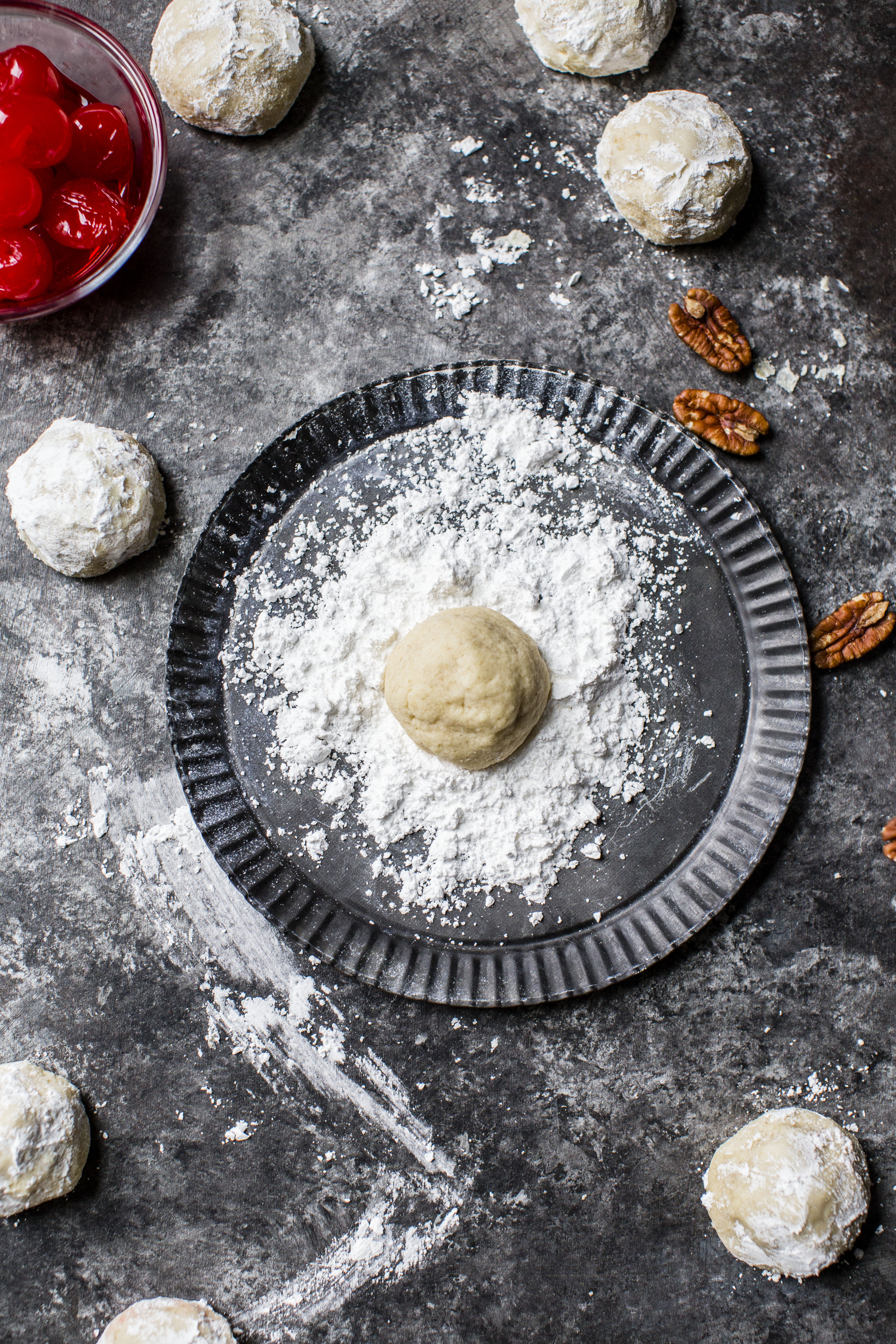 These classic butterball cookies are a favorite that my grandmother made every year at Christmas. They are a light cookie that isn't super sweet and the center is filled with either a pecan or maraschino cherry. Classic and delicious! I howsweeteats.com #butterball #cookies