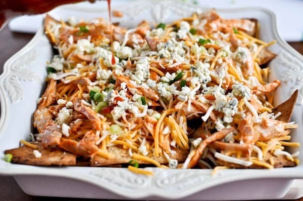 Layered Baked Buffalo Chicken Nachos I howsweeteats.com Layered Baked Buffalo Chicken Nachos I howsweeteats.com