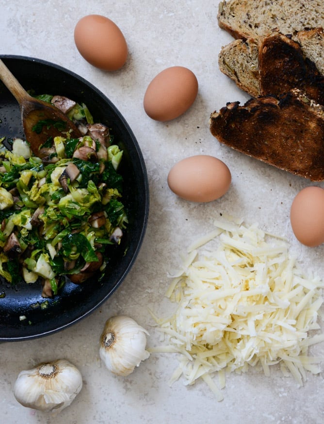 Broiled Fontina Toasts with Roasted Garlic and Poached Eggs I howsweeteats.com Broiled Fontina Toasts with Roasted Garlic and Poached Eggs I howsweeteats.com