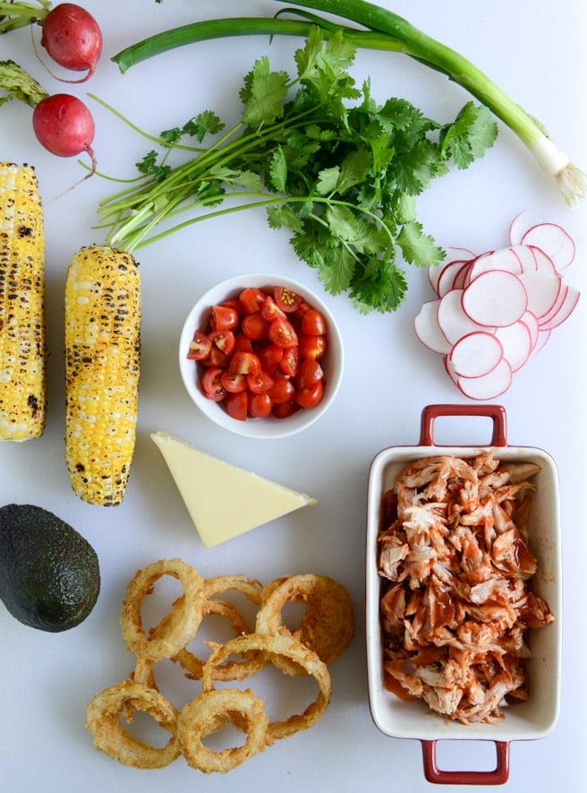 summer BBQ chicken nachos with buttermilk onion rings and white cheddar queso I howsweeteats.com