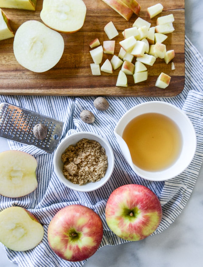 vanilla cinnamon roll dutch baby with apple bourbon compote and cream cheese icing I howsweeteats.com