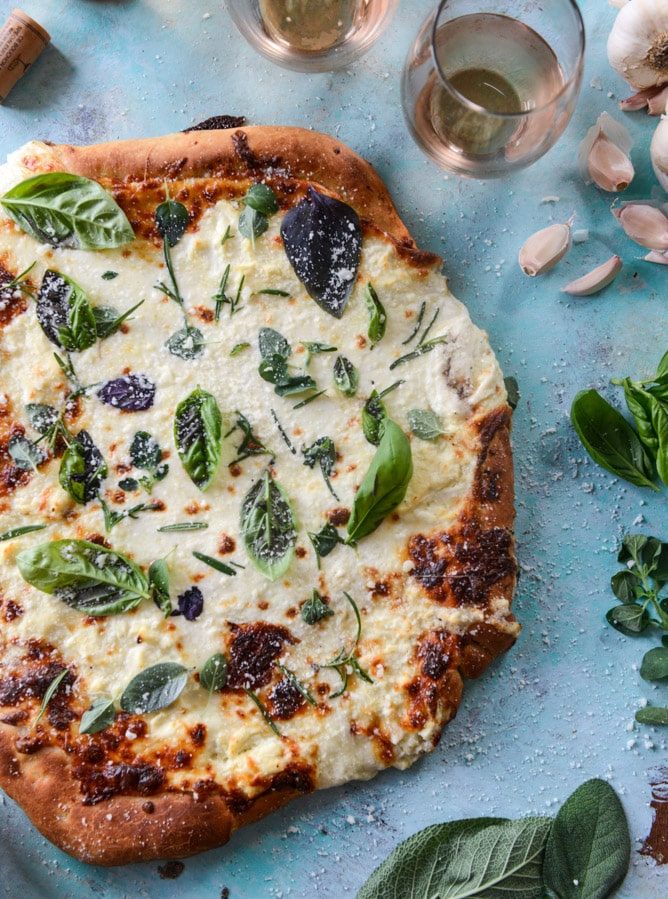 white pizza with garlic sauce and garden herbs I howsweeteats.com