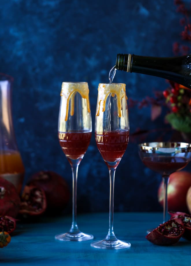 pomegranate cider mimosas with a salted caramel rim I howsweeteats.com #cocktails #thanksgiving #applecider #mimosas