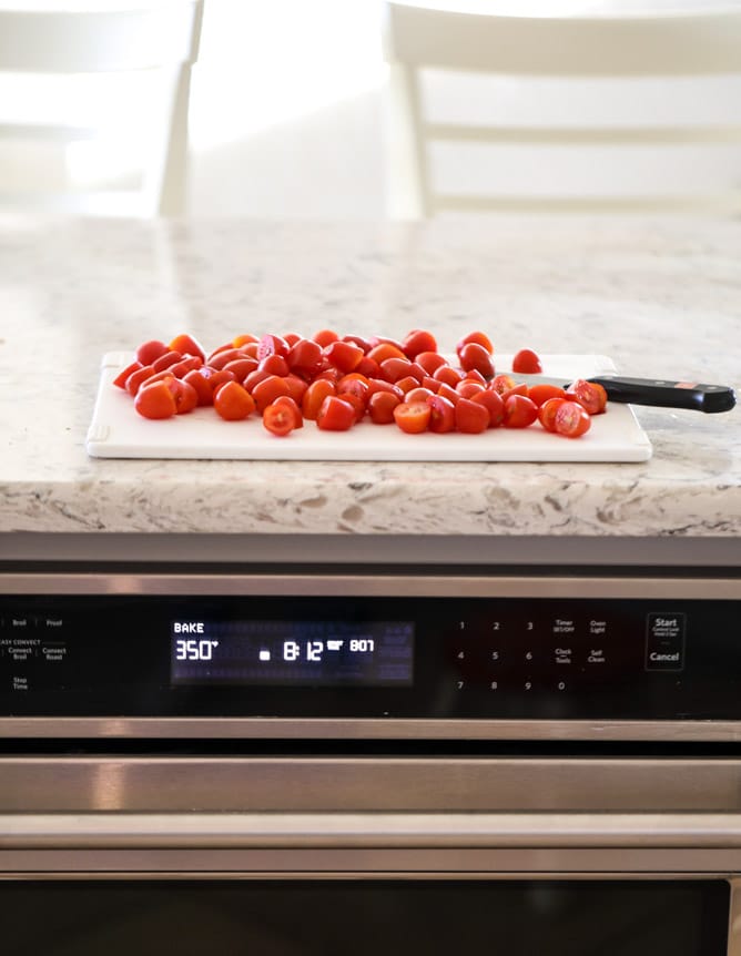 slow roasted cherry tomato pizza with garlic cream and arugula I howsweeteats.com #pizza #recipes