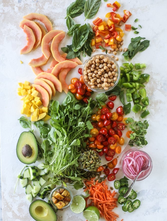 This spicy rainbow salad is chock full of gorgeous, fresh produces, chickpeas, plantains and herbs for one beautiful sight in a bowl. The rainbow salad is satisfying, filling, delicious with a touch of sweet and slightly spicy - everything you want in a meal! I howsweeteats.com #spicy #rainbow #salad
