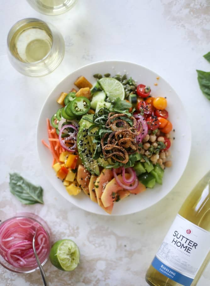 This spicy rainbow salad is chock full of gorgeous, fresh produces, chickpeas, plantains and herbs for one beautiful sight in a bowl. The rainbow salad is satisfying, filling, delicious with a touch of sweet and slightly spicy - everything you want in a meal! I howsweeteats.com #spicy #rainbow #salad