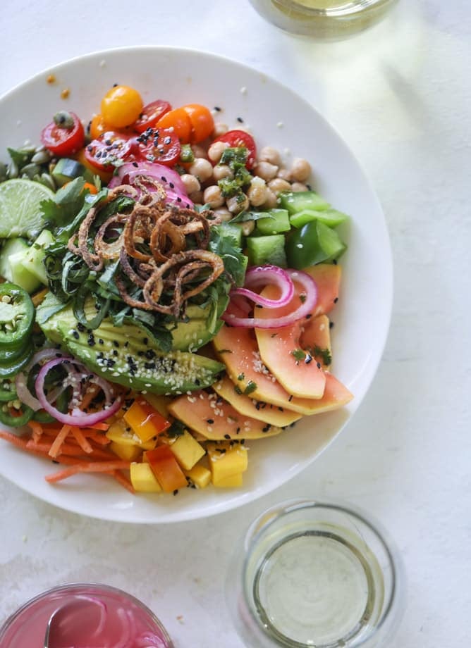 This spicy rainbow salad is chock full of gorgeous, fresh produces, chickpeas, plantains and herbs for one beautiful sight in a bowl. The rainbow salad is satisfying, filling, delicious with a touch of sweet and slightly spicy - everything you want in a meal! I howsweeteats.com #spicy #rainbow #salad