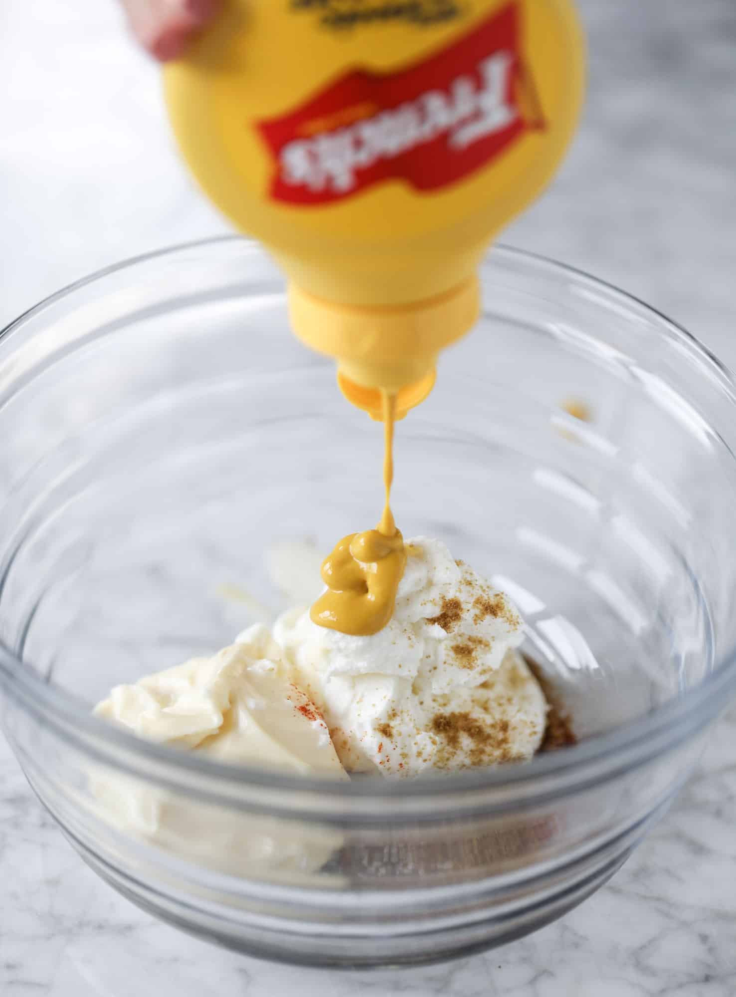 These smoky chicken salad stuffed avocados are lunchtime gold! They are super easy to throw together, satisfying and pretty darn great for you. Made with greek yogurt, some tangy mustard and dried cherries for sweetness, they are delish! I howsweeteats.com #chicken #salad #stuffed #avocados #greekyogurt