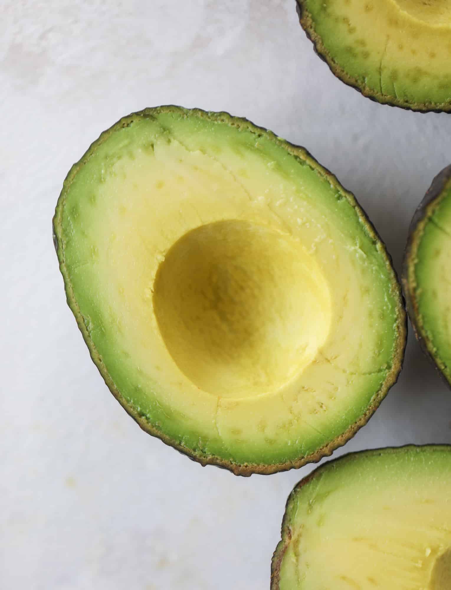 These smoky chicken salad stuffed avocados are lunchtime gold! They are super easy to throw together, satisfying and pretty darn great for you. Made with greek yogurt, some tangy mustard and dried cherries for sweetness, they are delish! I howsweeteats.com #chicken #salad #stuffed #avocados #greekyogurt