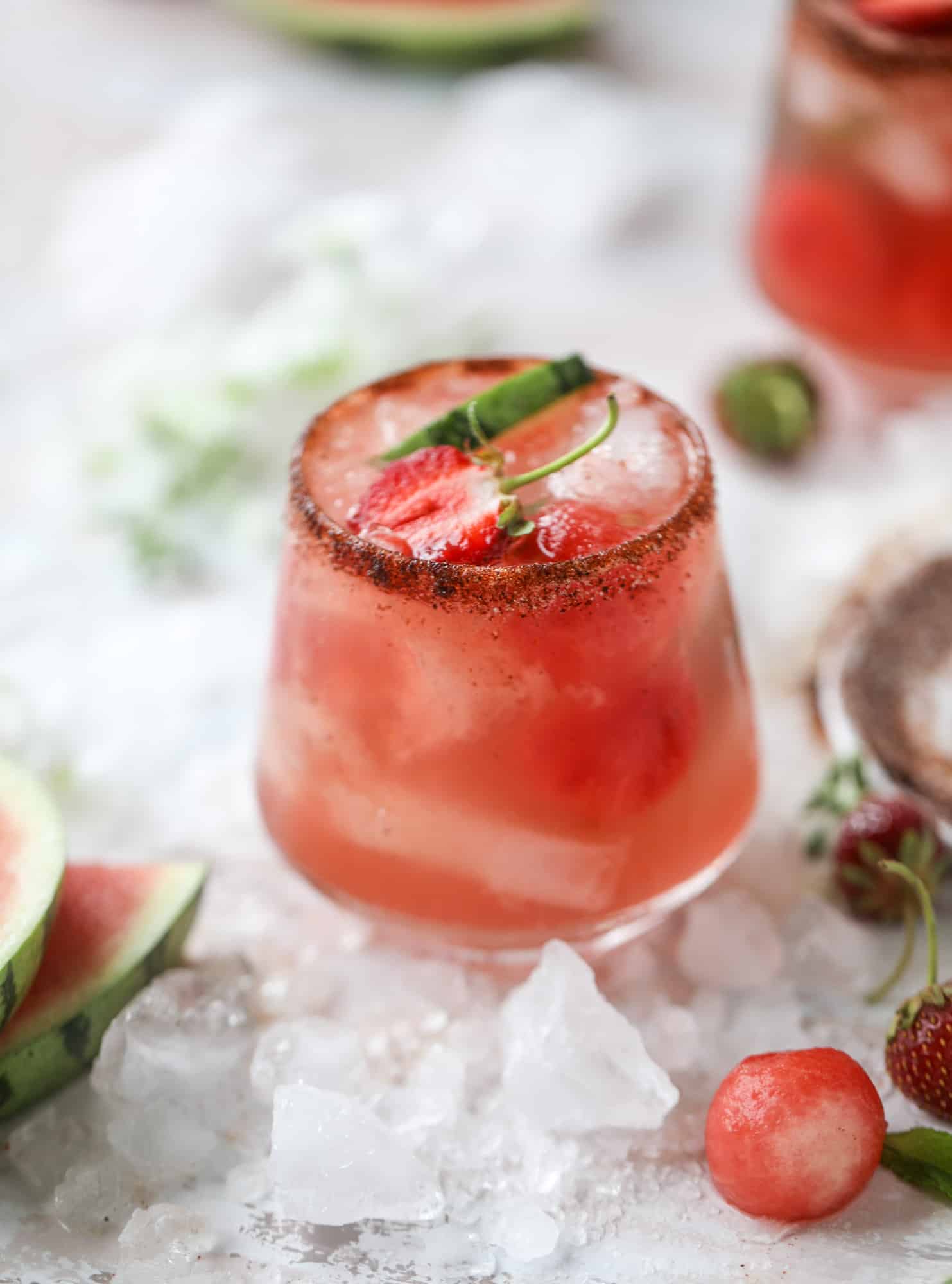 This spicy watermelon sangria is super refreshing, light, delicious and perfect for a hot summer day! Complete with an entire bottle of rosé, watermelon juice, melon balls, strawberries and brandy, this is the best summer cocktail in a pitcher! I howsweeteats.com #spicy #watermelon #sangria #cocktails #rosé