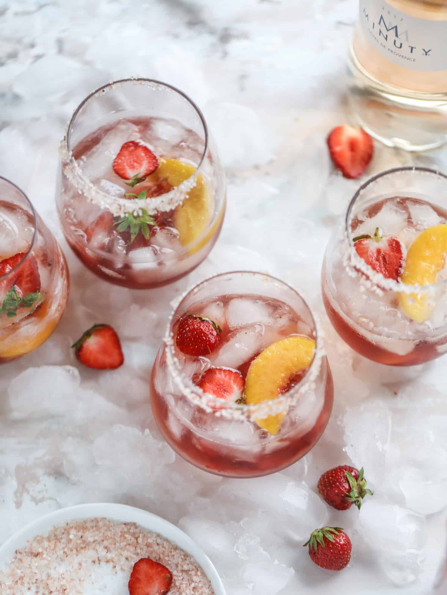 This tequila rosé spritz cocktail is perfectly refreshing for hot summer nights. A mix between a margarita and spritzer, this starts with muddled strawberries and honey, a shot of tequila and is topped off with your favorite rosé wine! I howsweeteats.com #tequila #rosé #wine #spritz #cocktail #strawberries