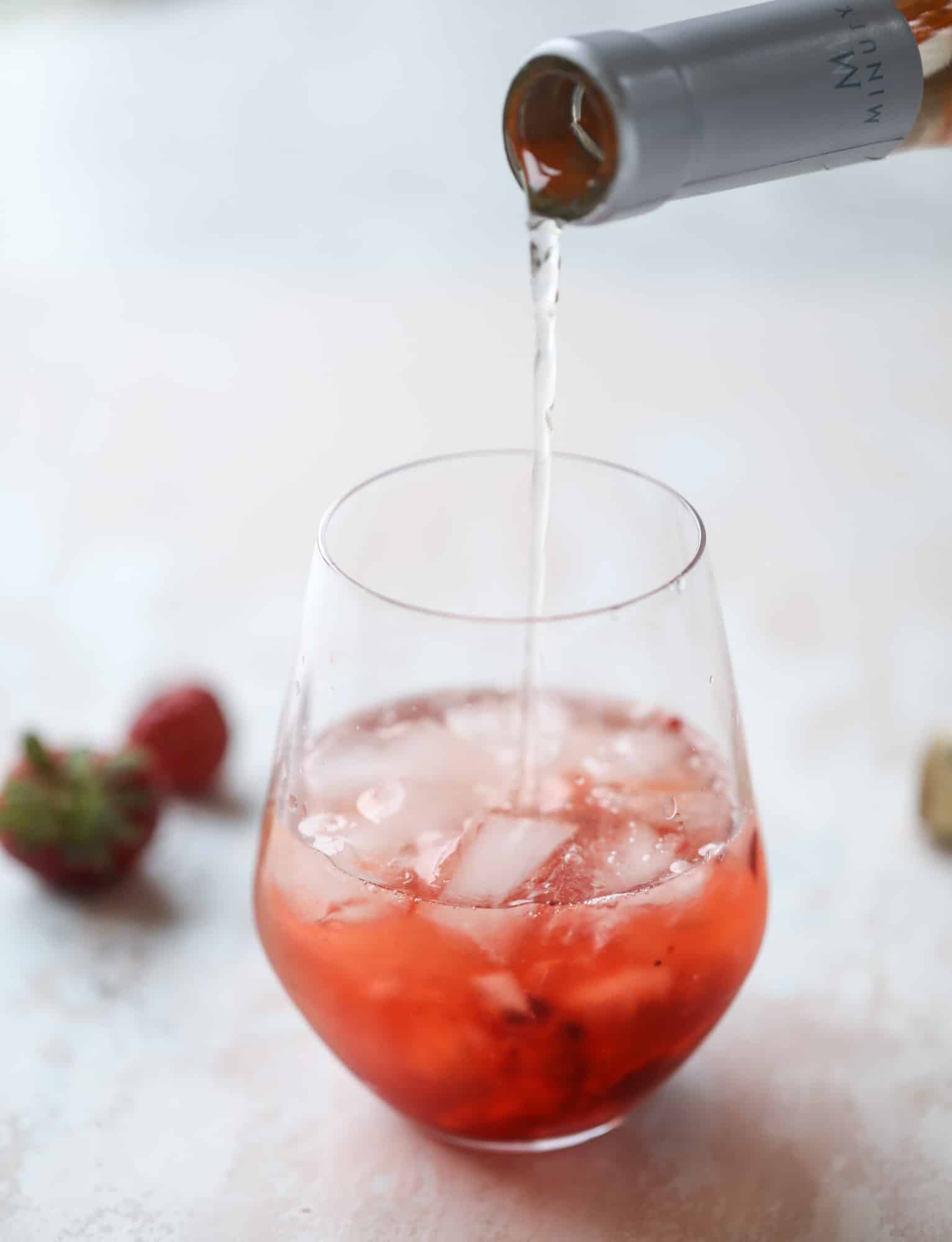 This tequila rosé spritz cocktail is perfectly refreshing for hot summer nights. A mix between a margarita and spritzer, this starts with muddled strawberries and honey, a shot of tequila and is topped off with your favorite rosé wine! I howsweeteats.com #tequila #rosé #wine #spritz #cocktail #strawberries