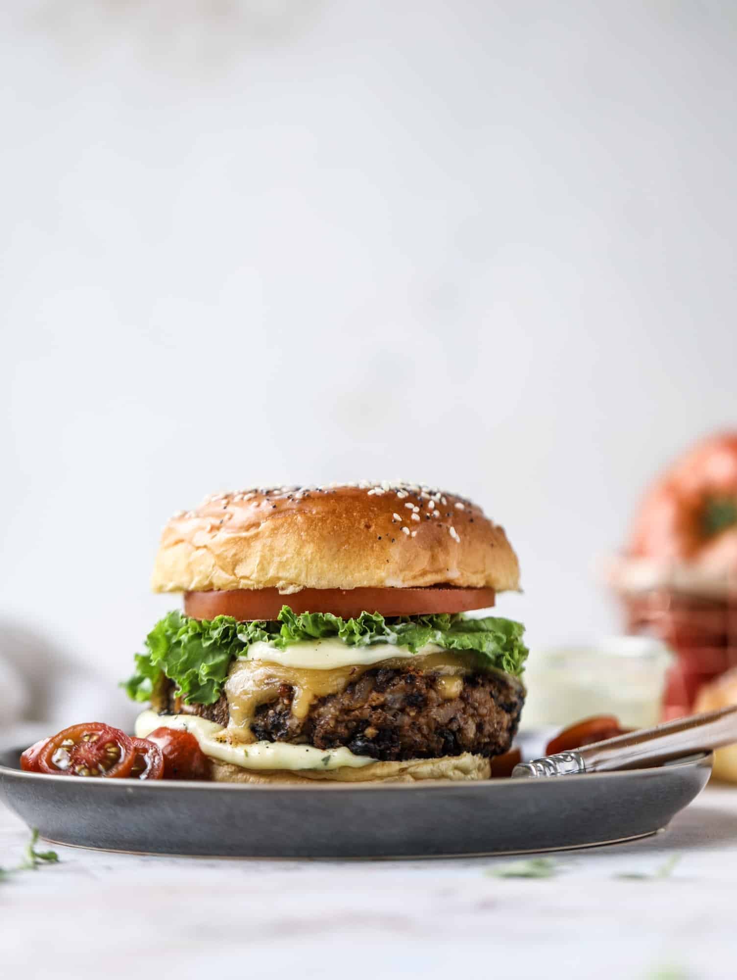 This is the best ever veggie burger and that is not an exaggeration! It's delicious, full of texture and chew, super satisfying and actually sticks together in the pan. You can serve it on buns, make a patty melt, a salad or lettuce wraps - perfection! I howsweeteats.com #best #veggie #burger #vegetarian #beans #quinoa