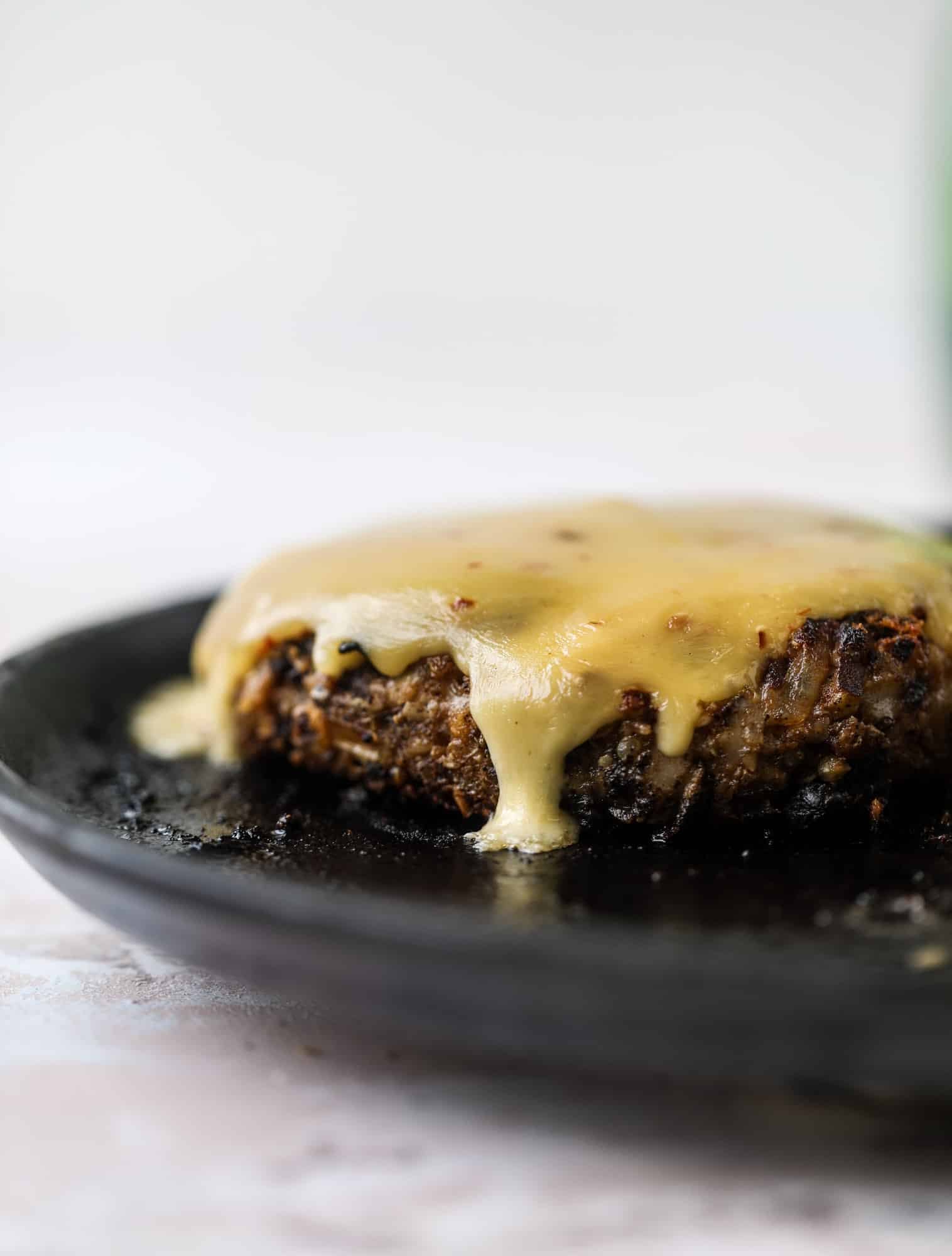 This is the best ever veggie burger and that is not an exaggeration! It's delicious, full of texture and chew, super satisfying and actually sticks together in the pan. You can serve it on buns, make a patty melt, a salad or lettuce wraps - perfection! I howsweeteats.com #best #veggie #burger #vegetarian #beans #quinoa