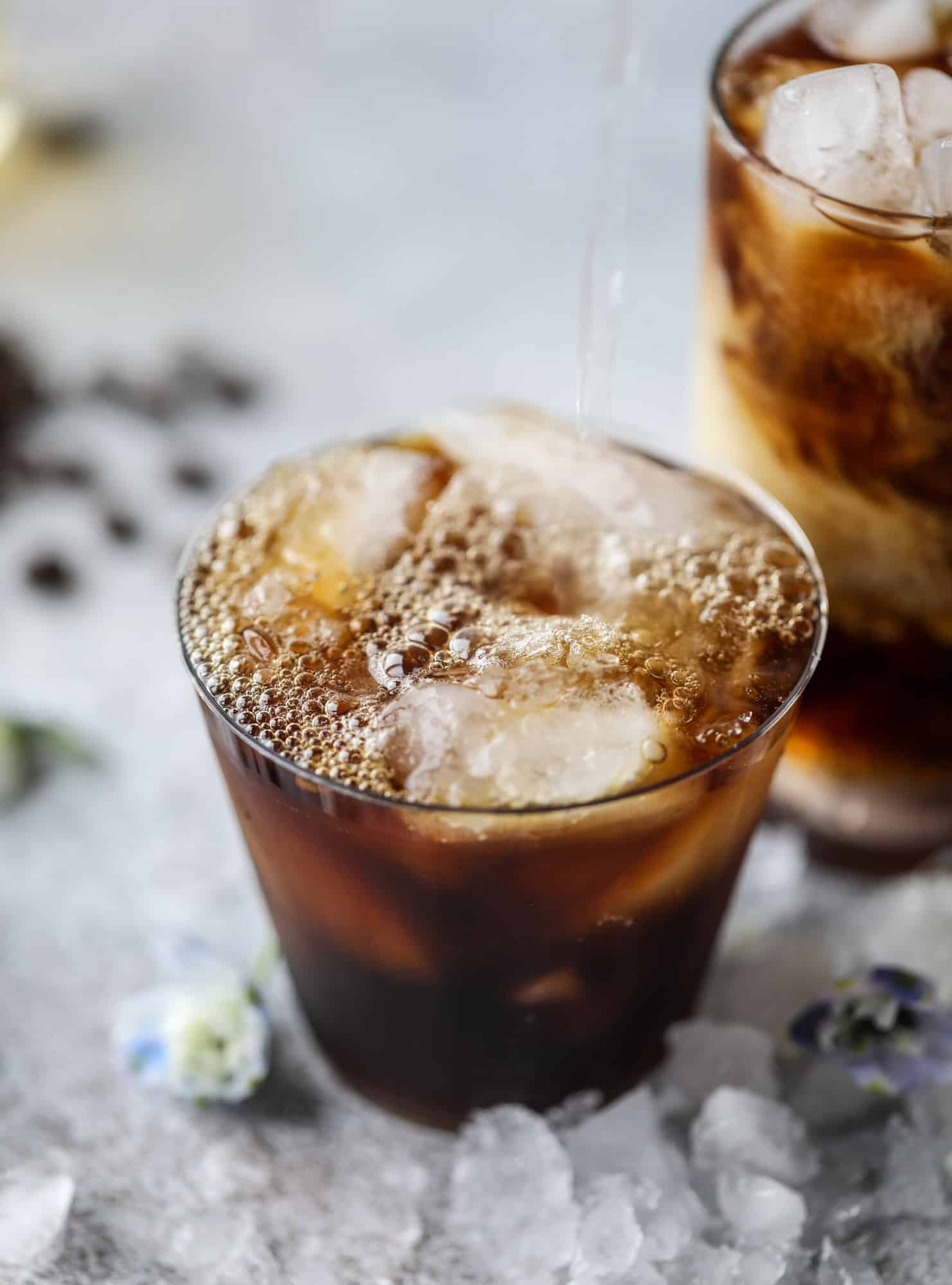 This iced coffee soda is so perfect for summer! Rich coconut syrup, cold brew coffee, cream (or coconut cream!) if you'd like it and lots of bubbly soda. Tastes refreshing, feels like a cocktail and still gives you a pick-me-up! I howsweeteats.com #iced #coffee #soda #coconut