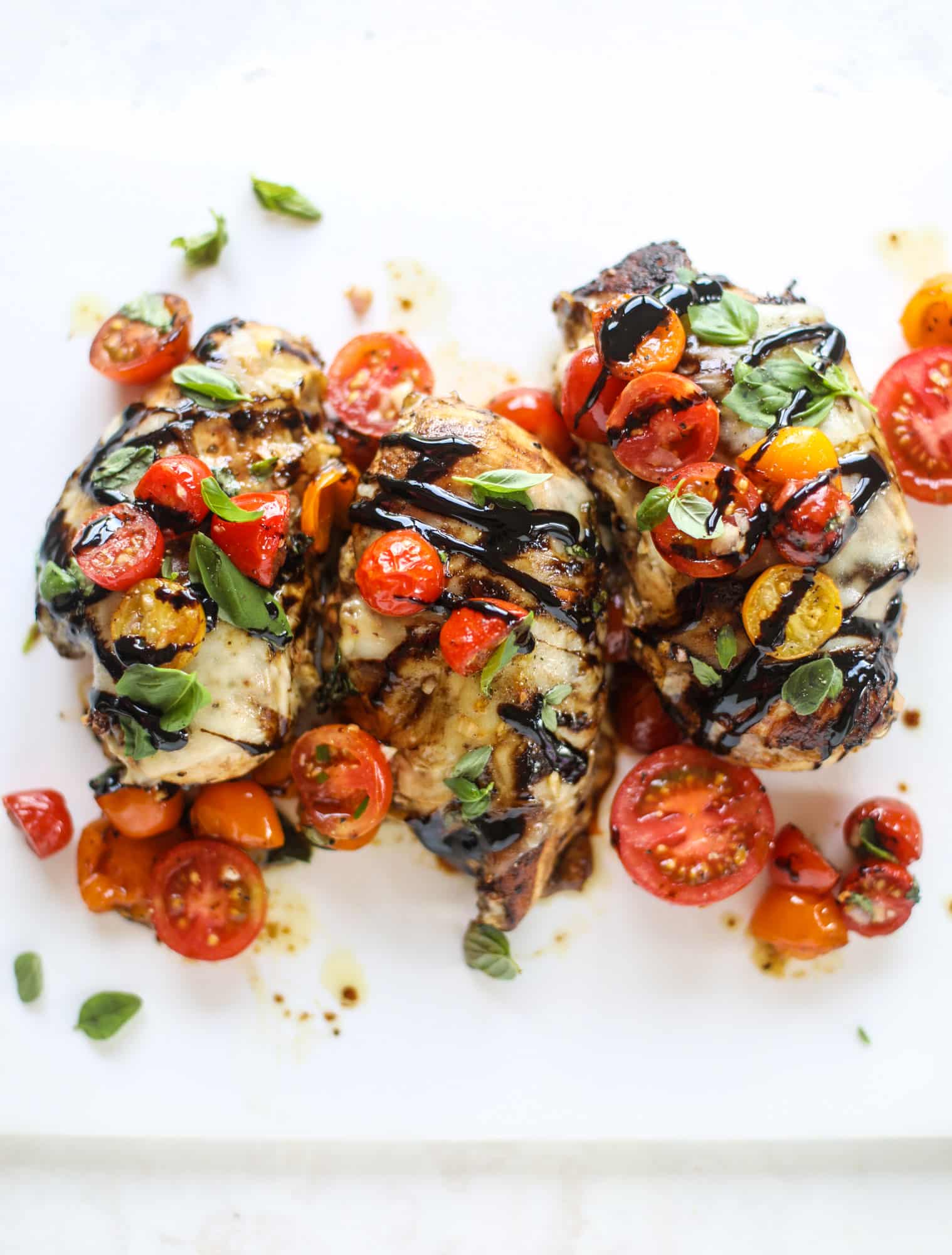 This bruschetta chicken is the perfect summer garden meal! Juicy, flavorful chicken topped with fresh tomatoes, garlic, basil and balsamic glaze, along with a touch of cheese. Served with pasta, it's an incredible meal. I howsweeteats.com #bruschetta #chicken #pasta #tomatoes #basil