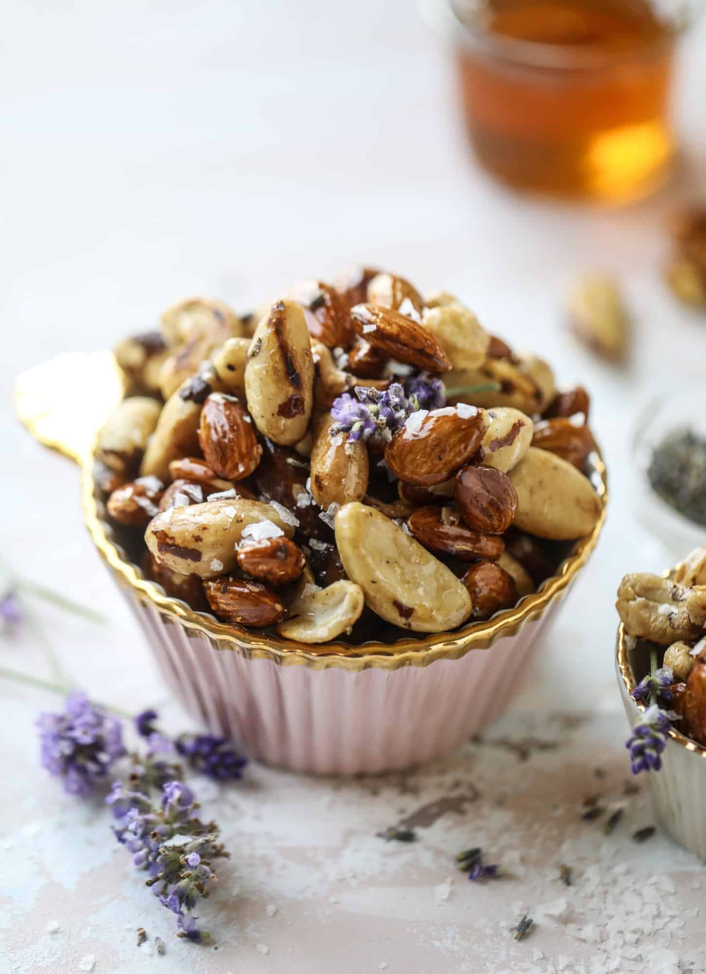These salted honey lavender nuts are the best snack to make for when you're on the go or when you need a perfect appetizer for your dinner party. Roasted, sweet and salty with a hint of lavender makes these irresistible! I howsweeteats.com #honey #lavender #nuts #salted #almonds #cashews #snacks #appetizers