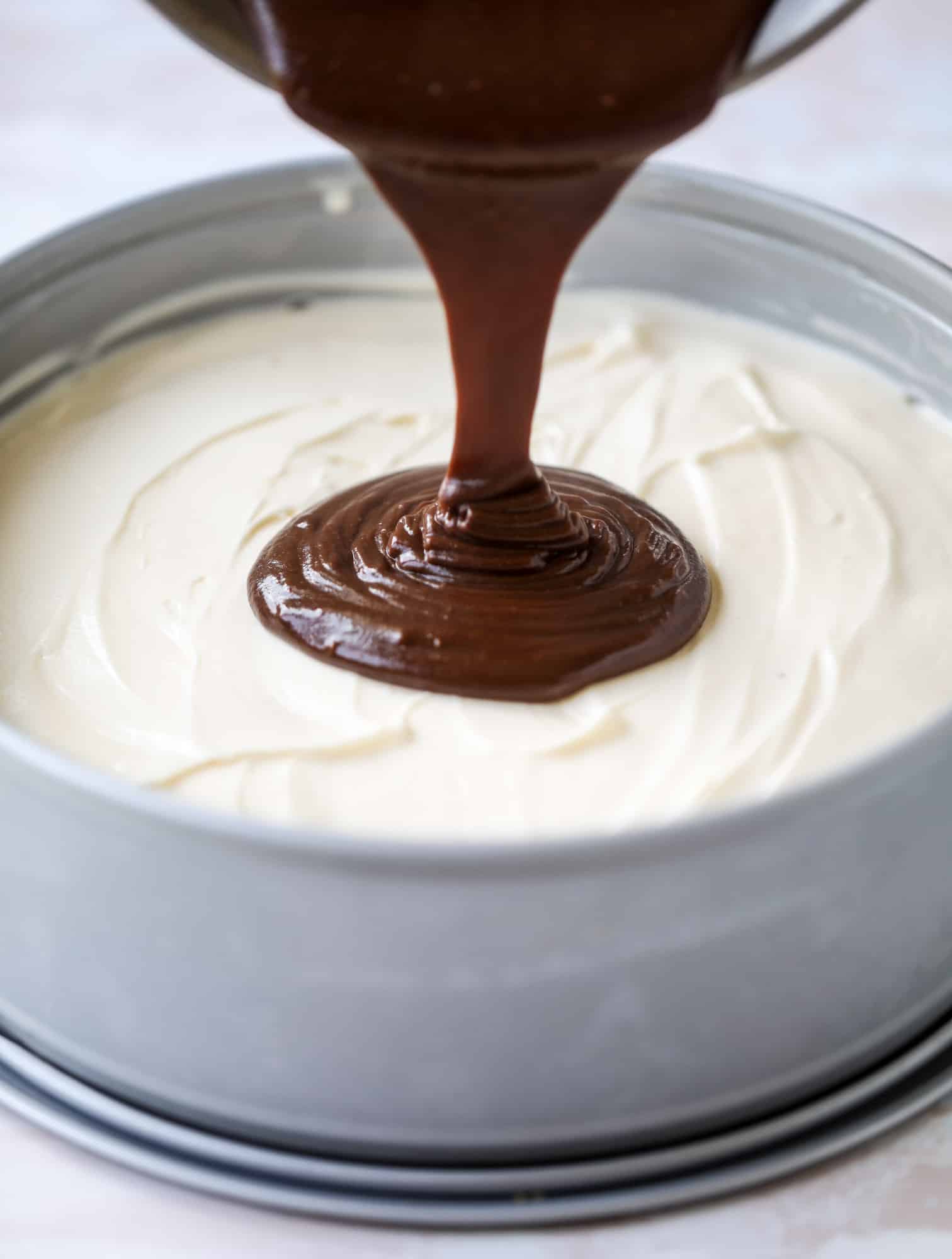 This peanut butter fudge ice cream cake is absolutely insane and perfect for summer! A sweet and savory pretzel crust, vanilla ice cream, homemade hot fudge and a peanut butter whipped cream layer take it to the next LEVEL. Delicious! I howsweeteats.com #icecream #cake #peanutbutter #chocolate #pretzel