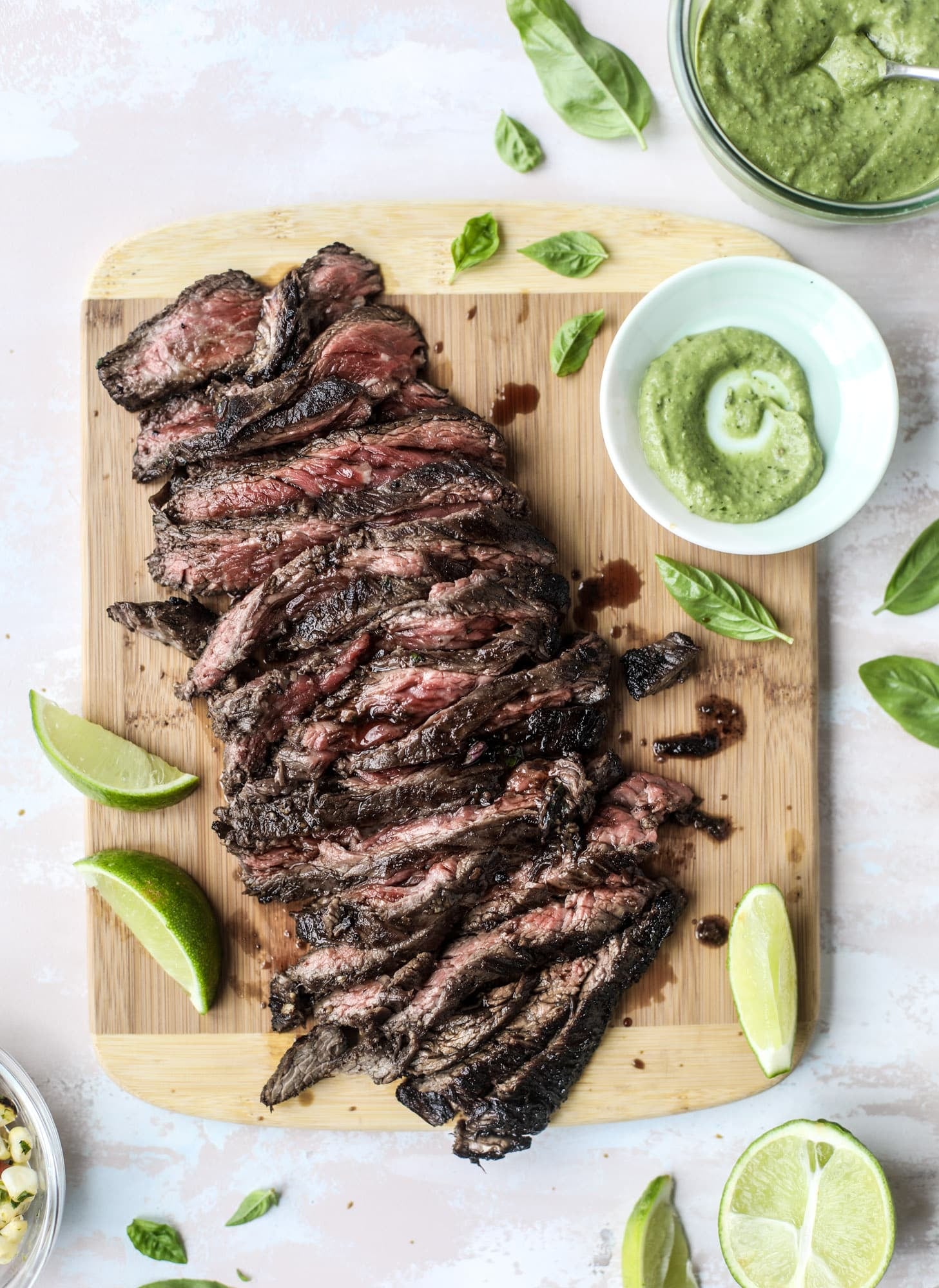 This skirt steak recipe is so super easy and delicious! Marinate it for a bit, prepare it to your liking then serve it with the most flavorful avocado pesto and grilled corn relish. Feels like a fancy restaurant meal and will make you love skirt steak forever! I howsweeteats.com #skirt #steak #avocado #pesto #corn #relish #recipes