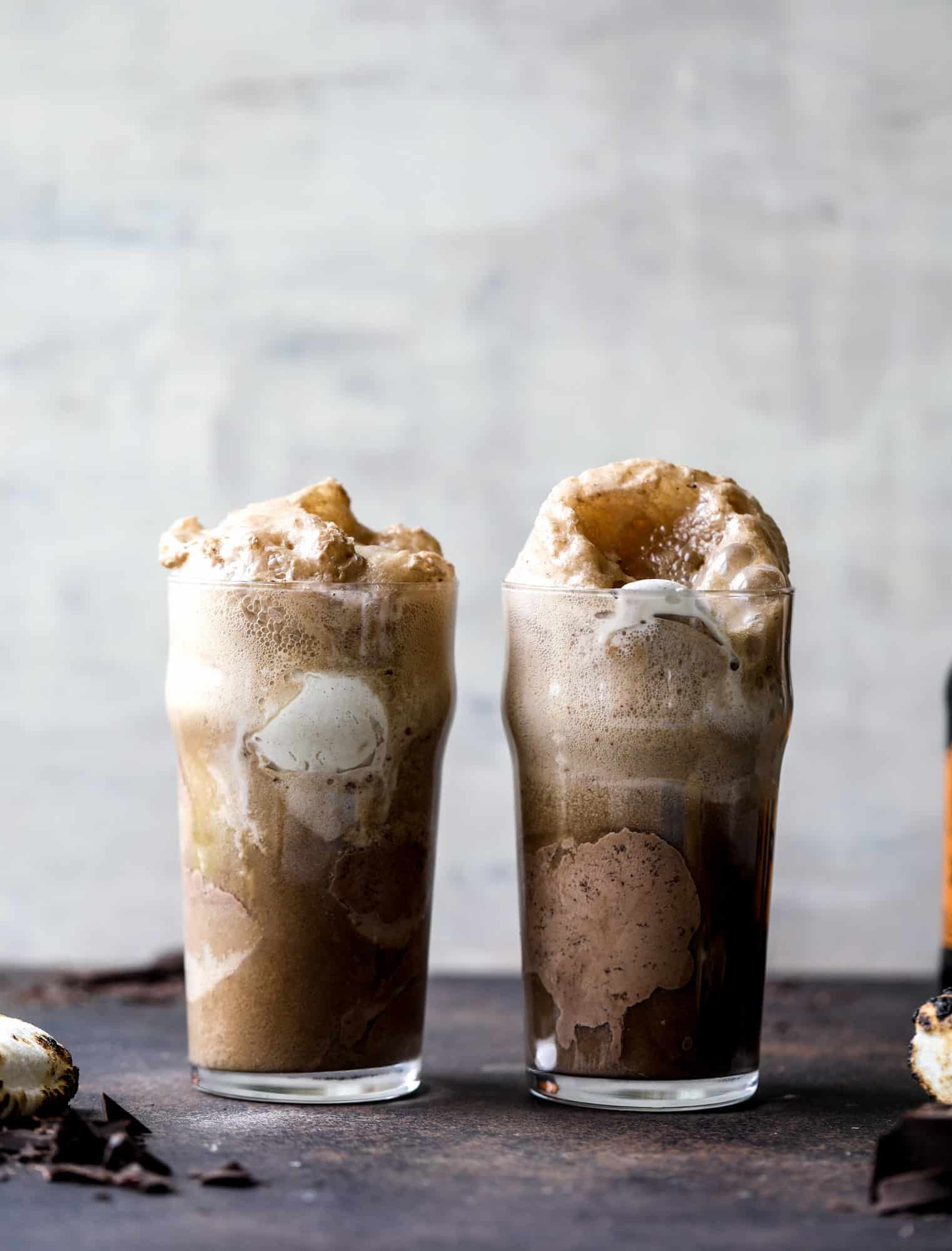 This is the most perfect root beer float, complete with both chocolate and vanilla ice creams. Topped with a smoky s'more, a chocolate fudge rim and a sprinkle of graham cracker crumbs take this super fun drink over the top! I howsweeteats.com #root #beer #float #summer #s'mores #drinks