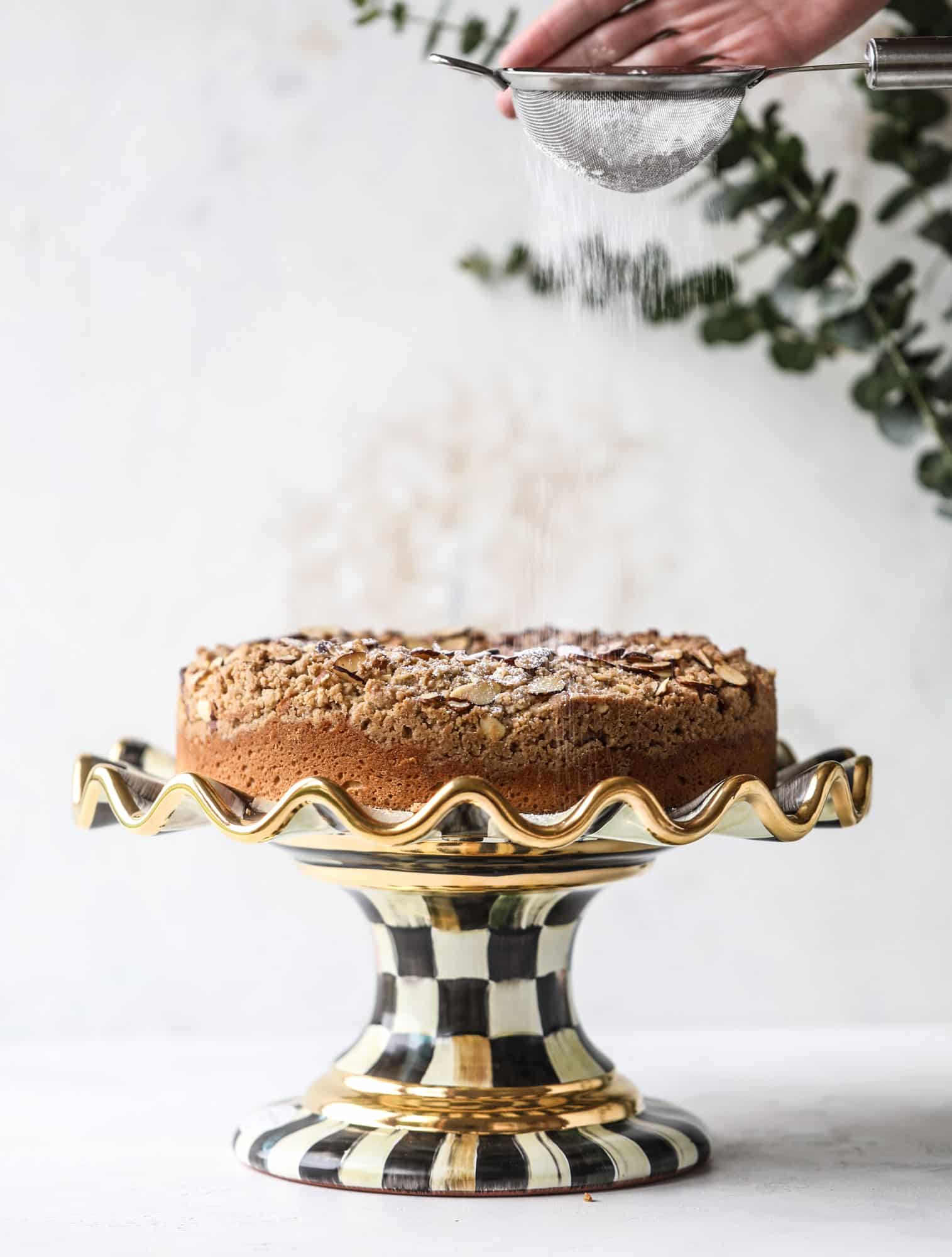 This almond crumb cake is so delicious and perfect for breakfast or dessert! It's full of delicious almond flavor and crunch and the crumb on top is so thick and perfect. It's like an almond croissant on steroids. I howsweeteats.com #almond #crumb #cake