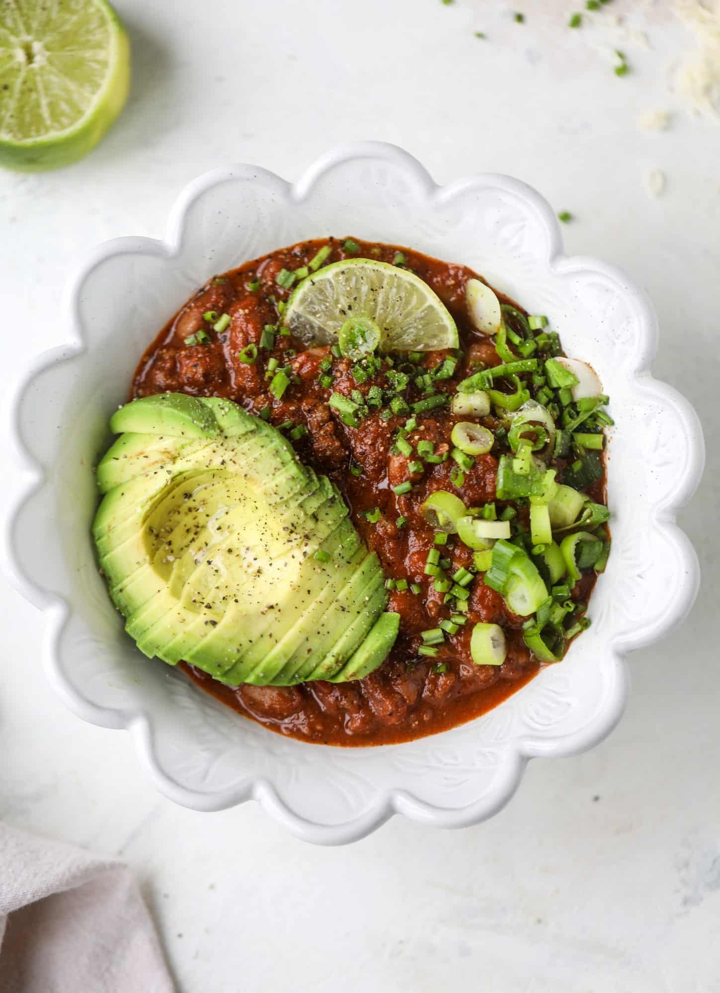 This fire and ice chili has a secret ingredient that makes it rich, velvety and insanely delicious. Dark chocolate ice cream is stirred in before serving and adds a crazy depth of flavor while bringing so much richness to your favorite bowl. You have to try it! I howsweeteats.com #chili #recipe #ice #cream #chili #bar