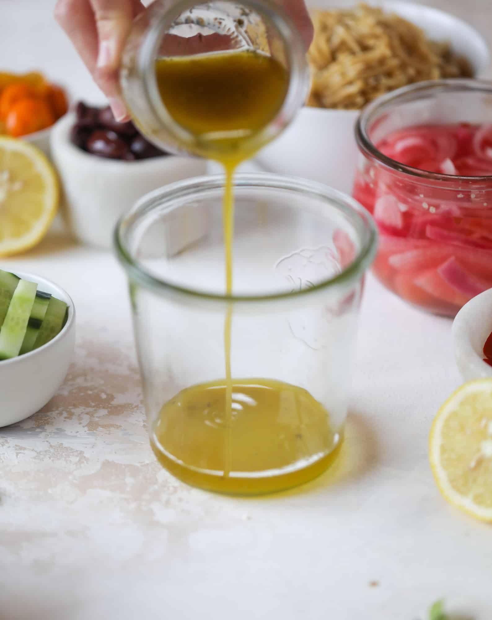 This incredible greek orzo salad in a jar is to die for! The recipe is so easy and flavorful, super satisfying and perfect for meal prep. This salad in a jar is a delicious lunch idea for the weekdays and keeps you feeling full and happy! I howsweeteats.com #salad #jar #greek #orzo #recipes #healthy #lunch #mealprep