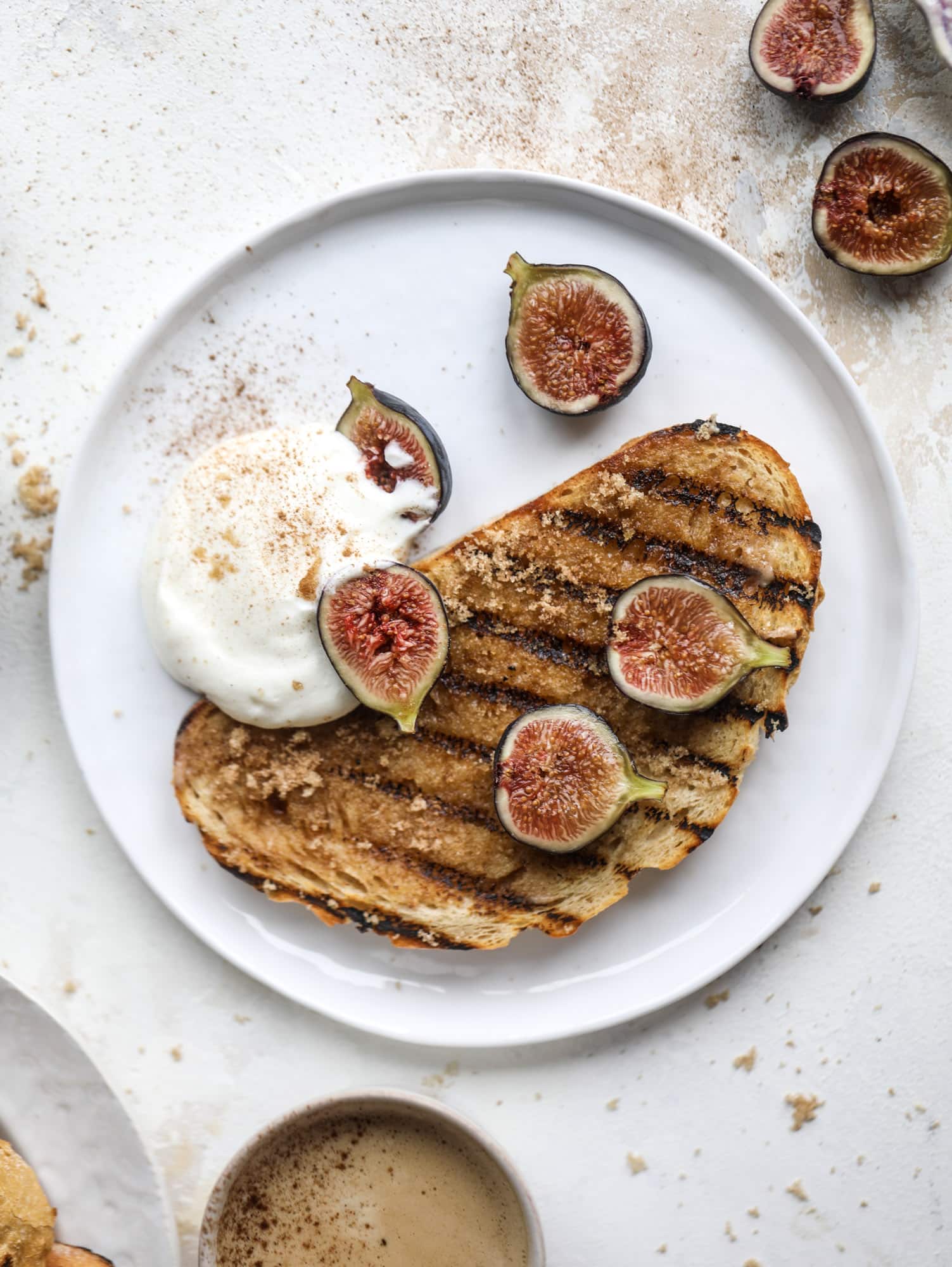 This cinnamon sugar toast is an absolutely dream! It's spread with a cinnamon brown sugar butter, grilled to perfection and served with creamy whipped ricotta cheese, fresh figs, honey, cinnamon and sliced almonds. I howsweeteats.com #cinnamon #sugar #toast #ricotta #figs #breakfast
