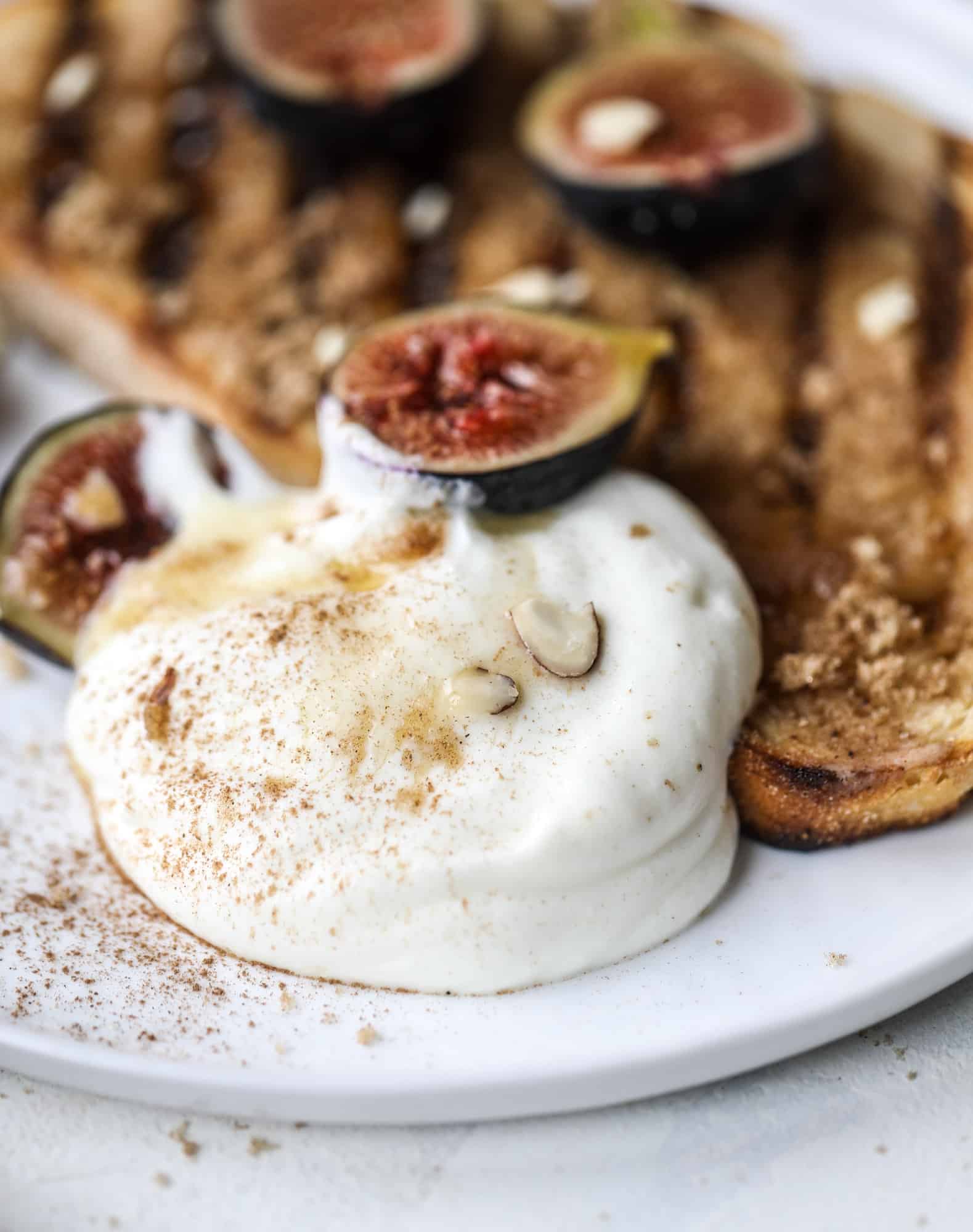This cinnamon sugar toast is an absolutely dream! It's spread with a cinnamon brown sugar butter, grilled to perfection and served with creamy whipped ricotta cheese, fresh figs, honey, cinnamon and sliced almonds. I howsweeteats.com #cinnamon #sugar #toast #ricotta #figs #breakfast