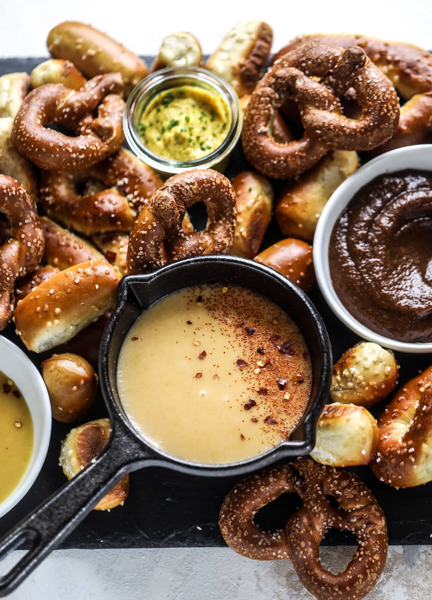 This is the cutest way ever to serve the best pumpkin beer! If you do a pumpkin beer party of a pumpkin beer tasting, this pumpkin cooler is an adorable (and easy!) way to make things festive. Kick it up with a hot pretzel bar and lots of dipping sauce too! I howsweeteats.com #pumpkin #beer #cooler #softpretzel #fall #cheese
