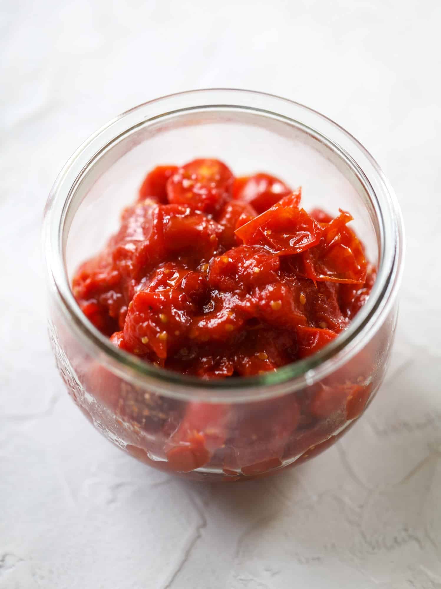 This ricotta jam jar is the perfect appetizer and snack to serve at a party! Based on the ricotta jam jar served at Nordstrom Cafe, it starts with creamy ricotta, is topped with flavorful basil pesto and a quick tomato jam. Serve with crunchy bread and dip dip dip! I howsweeteats.com #ricotta #jam #jar #nordstrom #tomato #pesto #appetizer #dip
