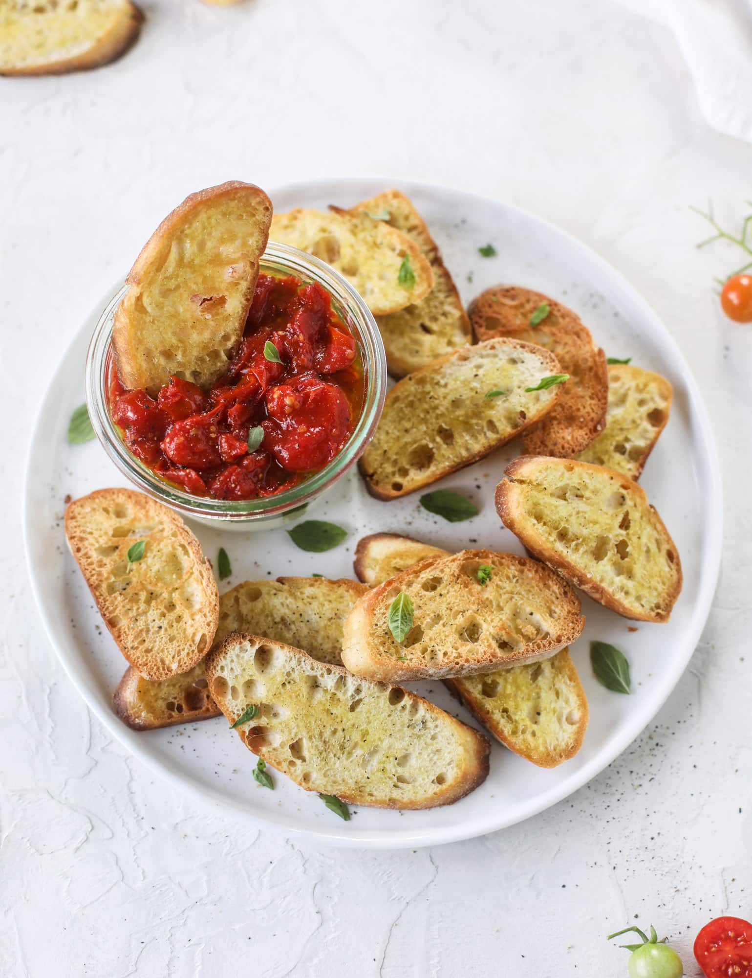 This ricotta jam jar is the perfect appetizer and snack to serve at a party! Based on the ricotta jam jar served at Nordstrom Cafe, it starts with creamy ricotta, is topped with flavorful basil pesto and a quick tomato jam. Serve with crunchy bread and dip dip dip! I howsweeteats.com #ricotta #jam #jar #nordstrom #tomato #pesto #appetizer #dip