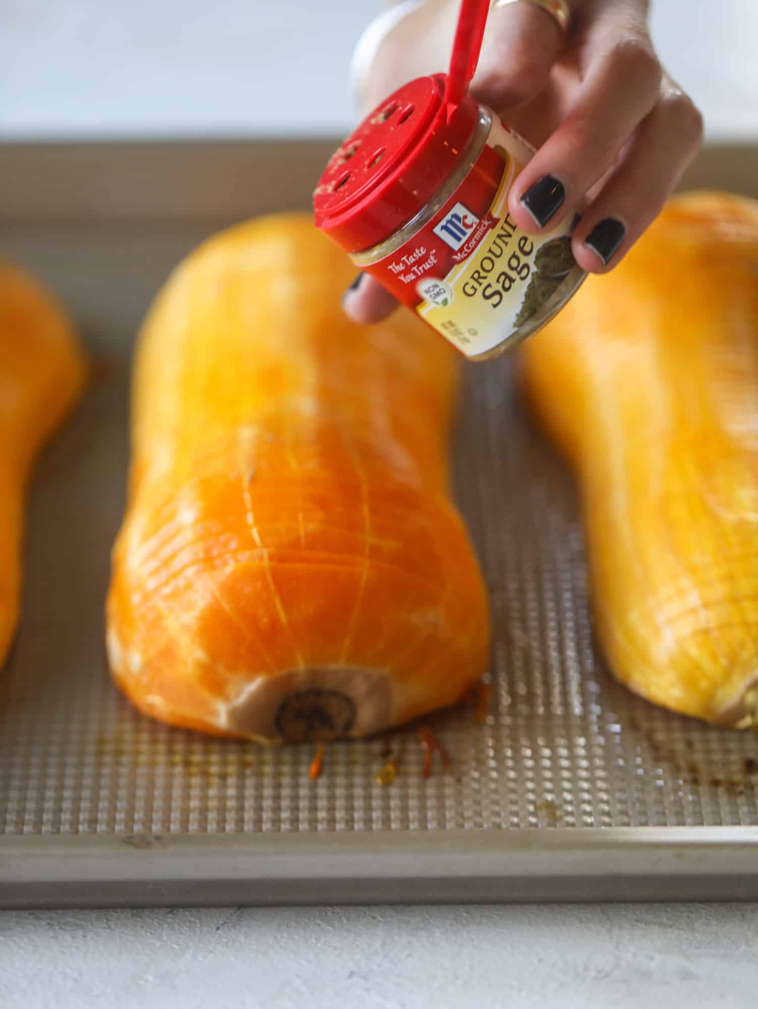 This hasselback butternut squash is perfect for Thanksgiving - and you can easily make it two ways! We have a maple pecan hassleback butternut squash and a brown butter sage hasselback butternut squash. Delicious! I howsweeteats.com #hasselback #butternutsquash