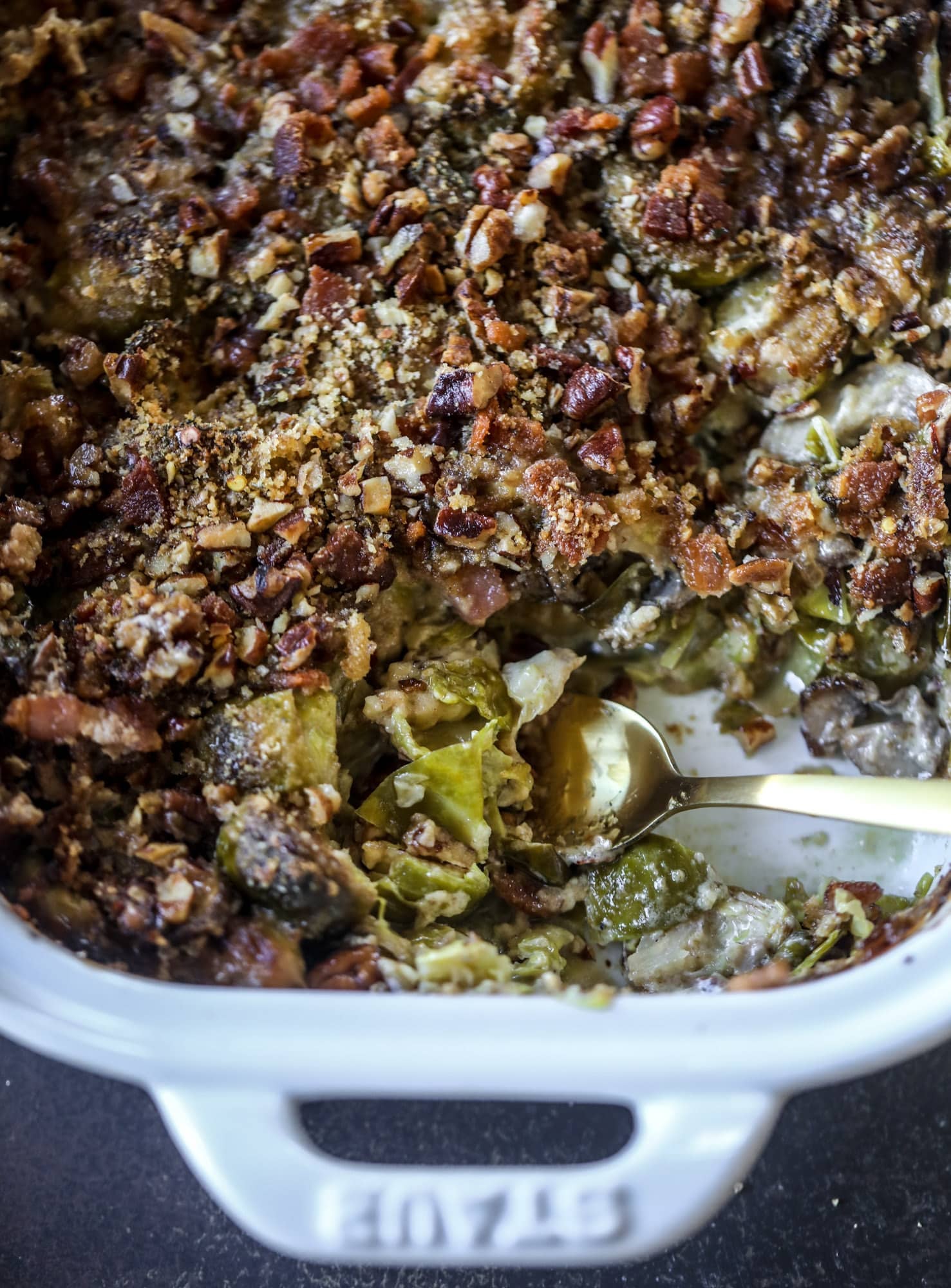 This brussels sprouts gratin is heaven in a dish! It's super flavorful, delicious and comes together to create a fabulous side dish for Thanksgiving or the holidays. Pancetta and cheese turn this in to flavor town - you won't be able to stop eating it! I howsweeteats.com #brusselssprouts #gratin