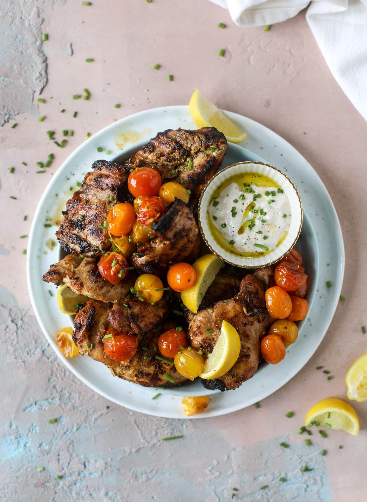 This yogurt marinated chicken recipe is super flavorful, tender, juicy and delicious. The fresh lemon adds a kick of flavor and it's a versatile recipe you can make for lunch or dinner. Grill it and serve with your favorite side, then use the leftovers for lunch! I howsweeteats.com #yogurt #chicken #lemon #grilled #healthy #recipes