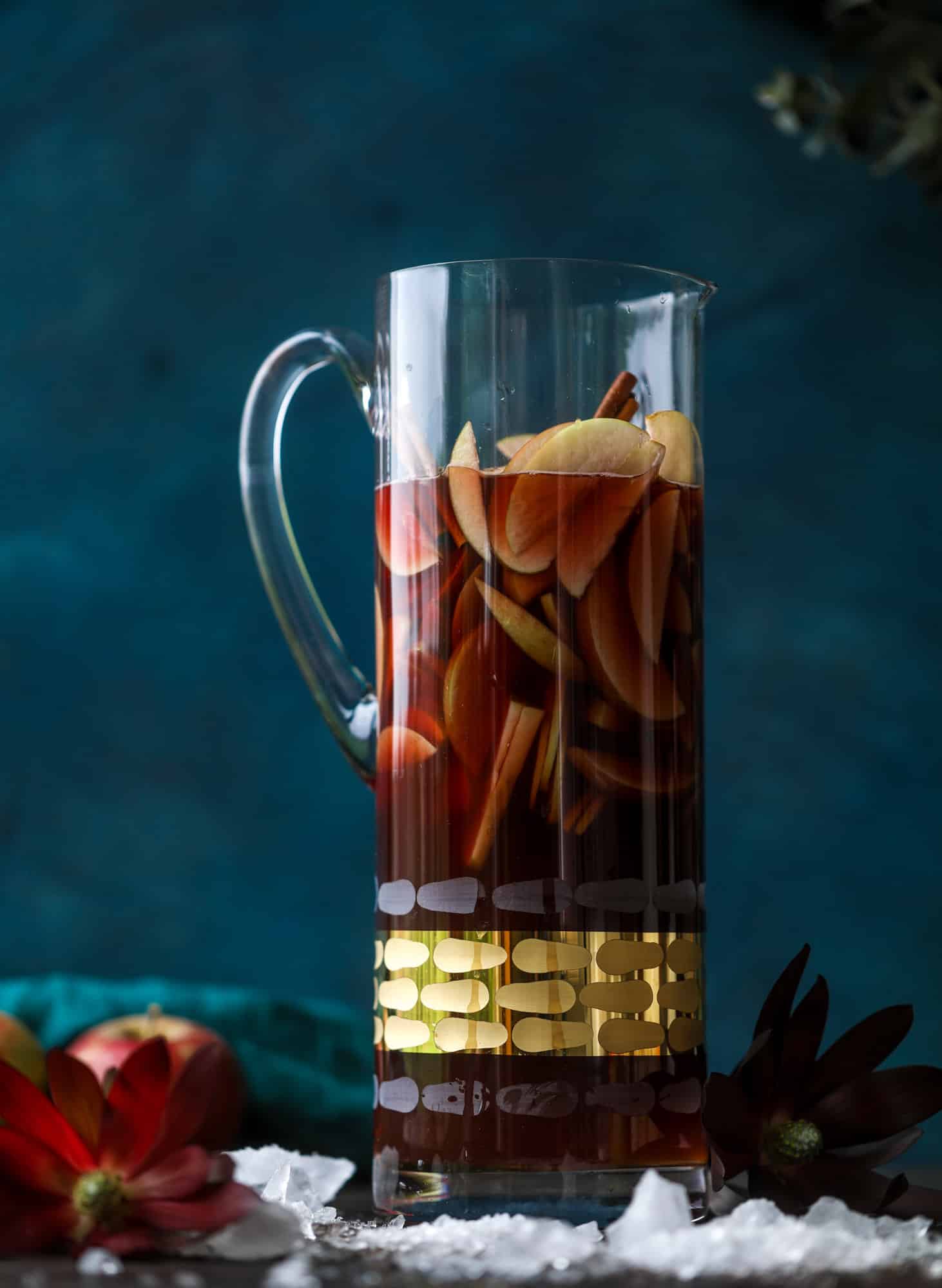 This red apple cider sangria will soon because a staple for your fall! It's delicious and not too sweet, with a base of red wine, apple cider and maple syrup. Cinnamon sticks and apple slices round out the pitcher and it's so flavorful and perfect for the season! I howsweeteats.com #red #apple #cider #sangria