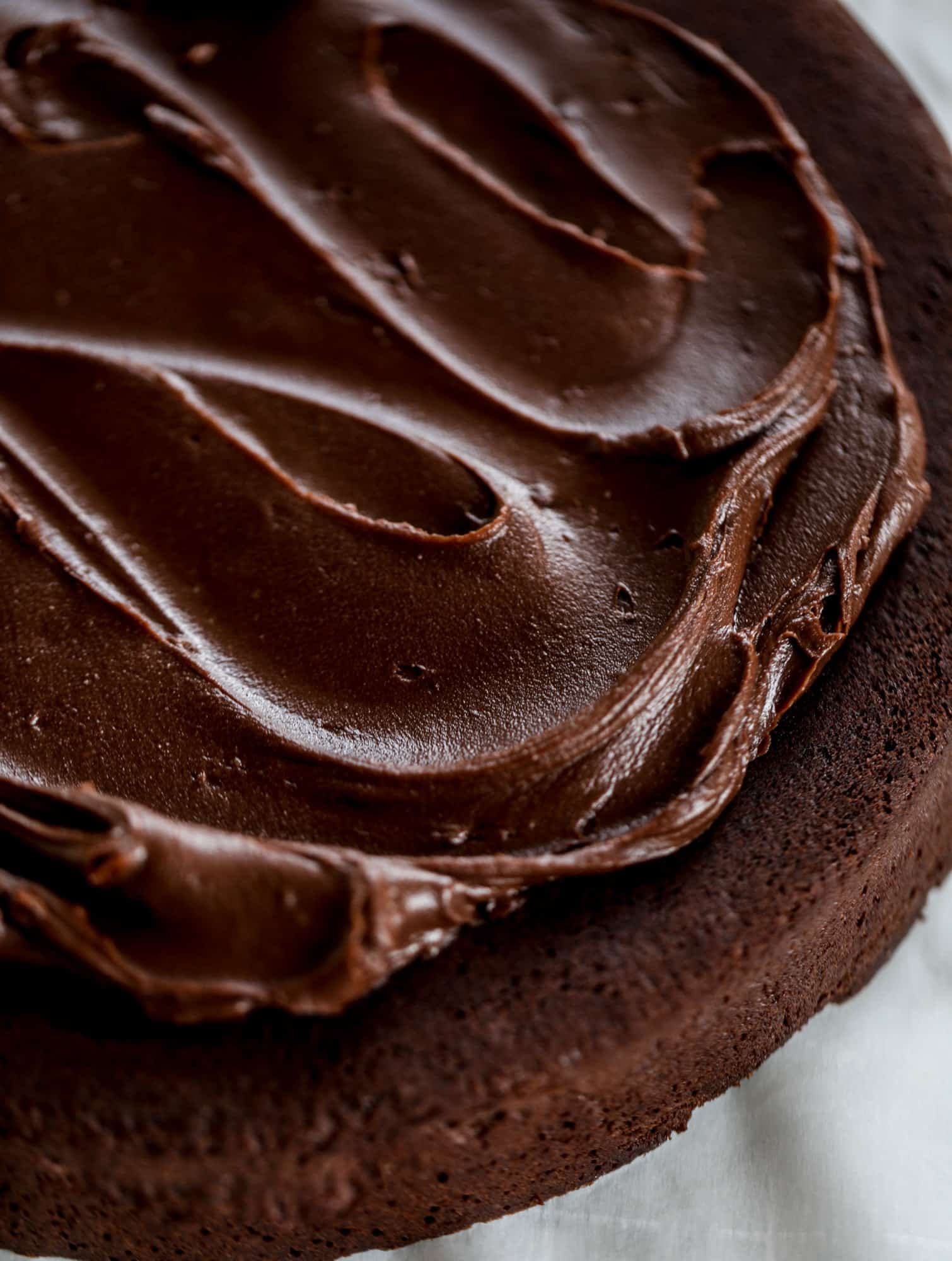 This salted dark chocolate stout cake is absolutely divine! It's ridiculously rich and perfect for a crowd or a party. Pumpkin stout batter is baked into fluffy laters and covered in a super fudgy chocolate ganache. Perfect for chocolate lovers! I howsweeteats.com #dark #chocolate #stout #cake #salted