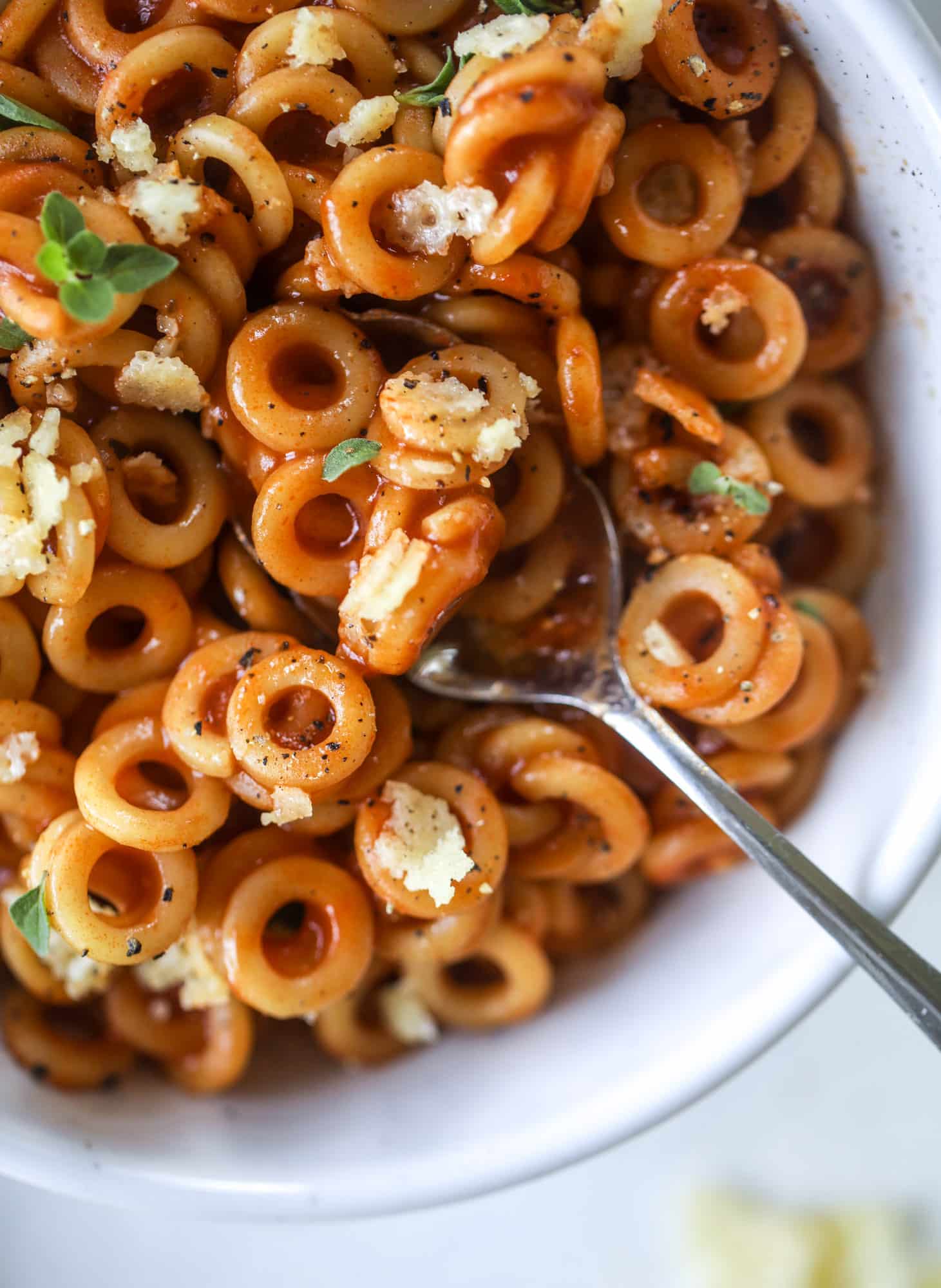These homemade spaghettios are the ultimate comfort food! They come together in less than 30 minutes, are super easy and flavorful and topped with crispy crunchy manchego cheese that takes the taste over the top! I howsweeteats.com #homemade #spaghettios