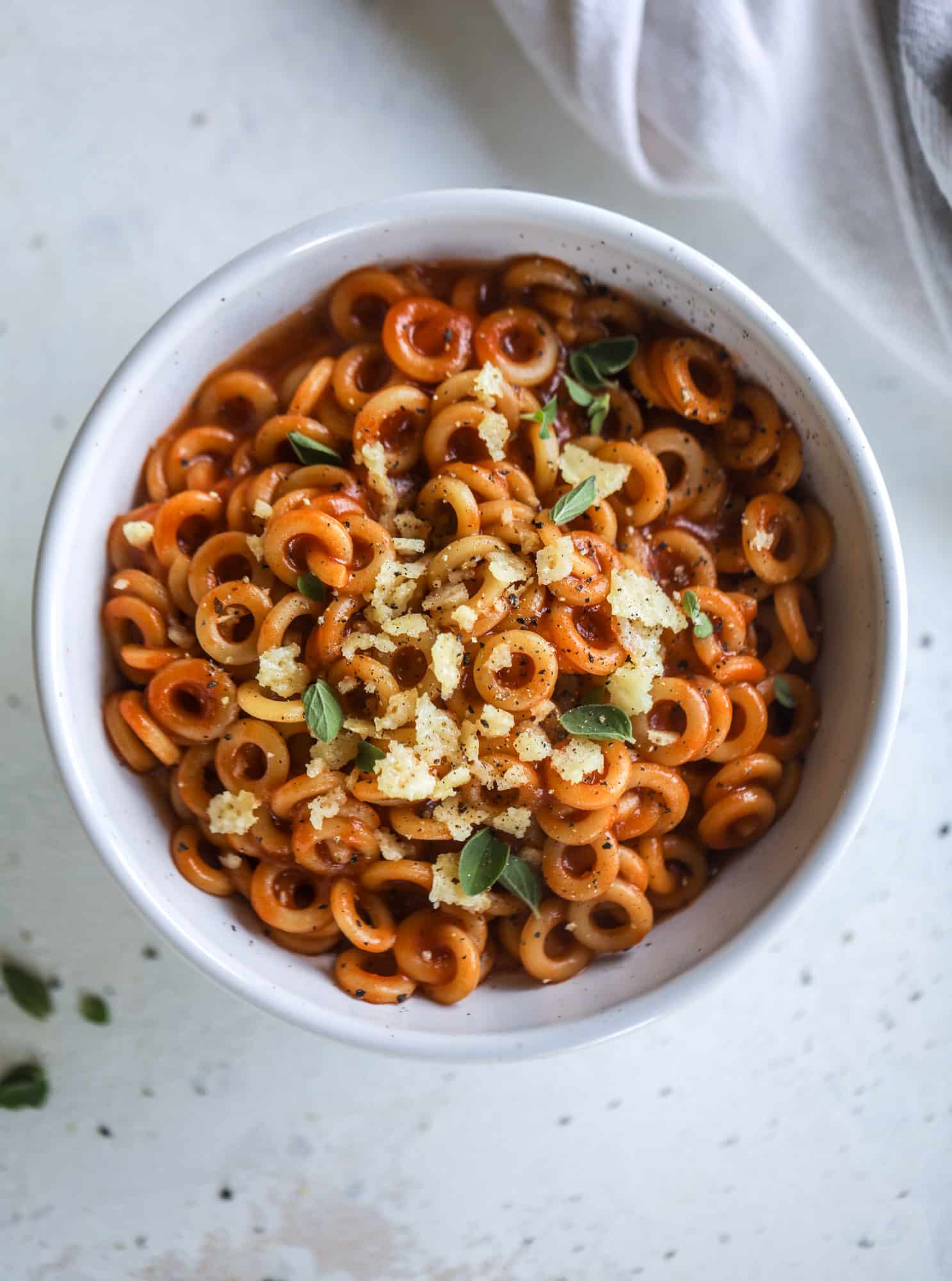 These homemade spaghettios are the ultimate comfort food! They come together in less than 30 minutes, are super easy and flavorful and topped with crispy crunchy manchego cheese that takes the taste over the top! I howsweeteats.com #homemade #spaghettios