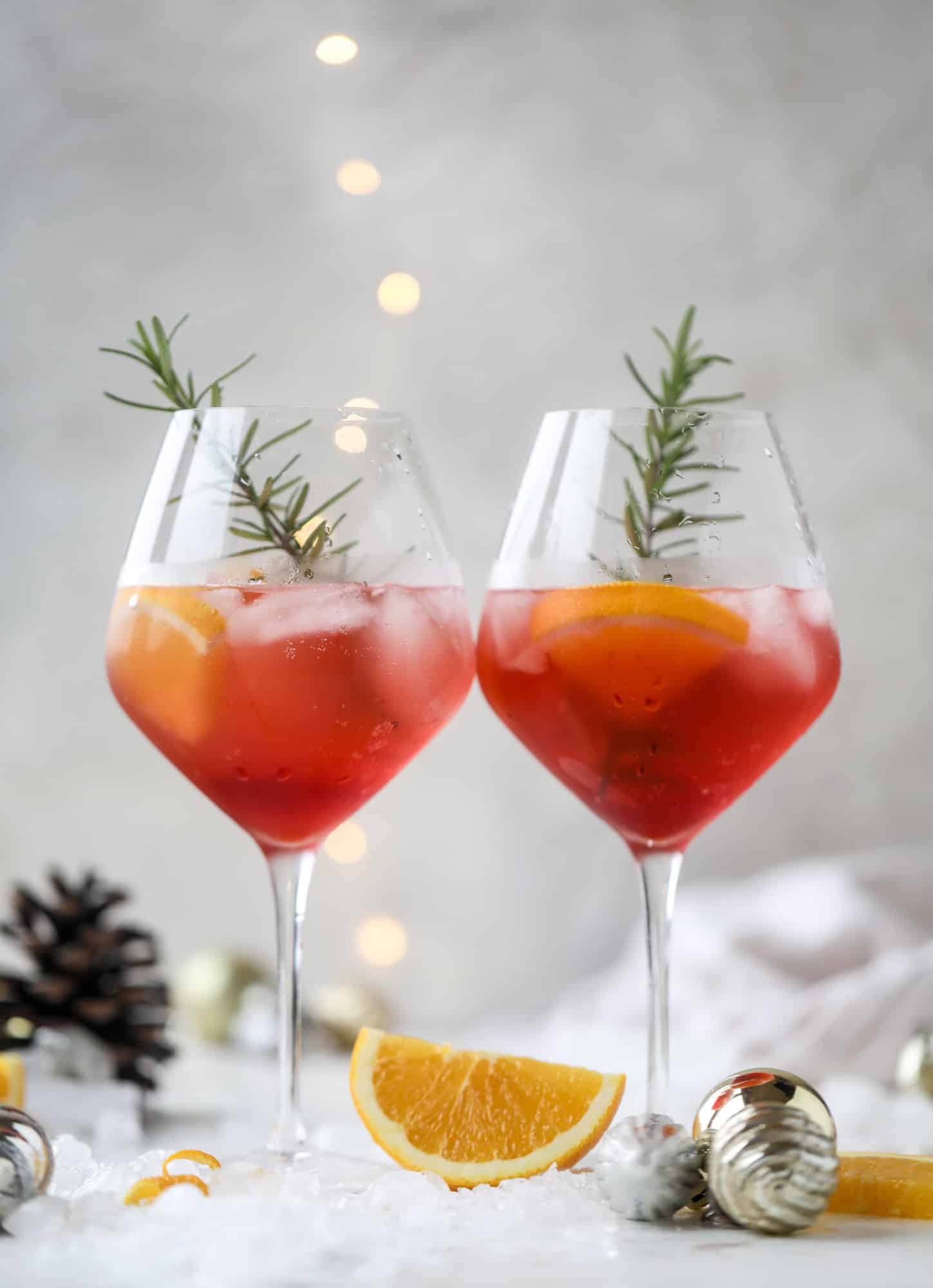 This winter aperol spritz cocktail is a seasonal spin on the classic aperol spritz! Festive cranberry and classic orange come together with prosecco and club soda to create a super light and refreshing cocktail for the holidays! I howsweeteats.com #aperol #spritz