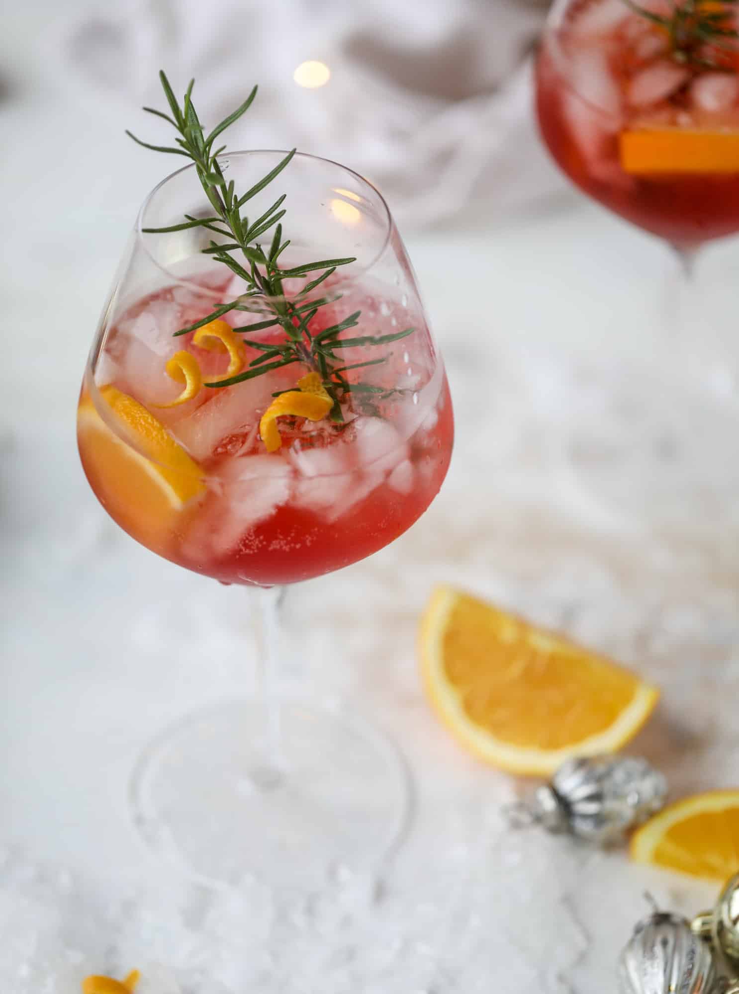 This winter aperol spritz cocktail is a seasonal spin on the classic aperol spritz! Festive cranberry and classic orange come together with prosecco and club soda to create a super light and refreshing cocktail for the holidays! I howsweeteats.com #aperol #spritz