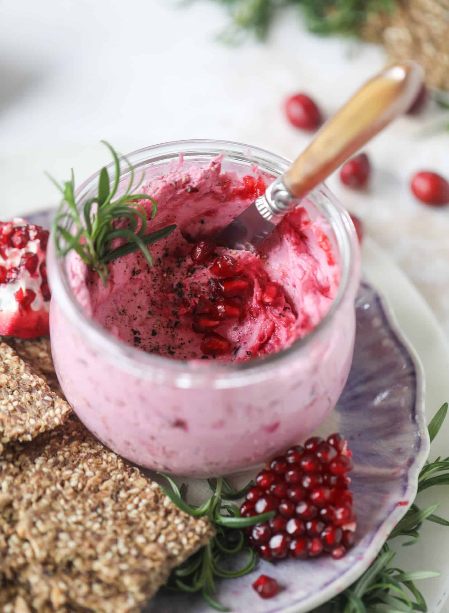 This whipped cranberry goat cheese spread is the perfect holiday appetizer! You can make it ahead of time and serve it with a cheese board or bread and crackers - before or during the meal! Plus it's super pretty too! I howsweeteats.com #cranberry #goatcheese