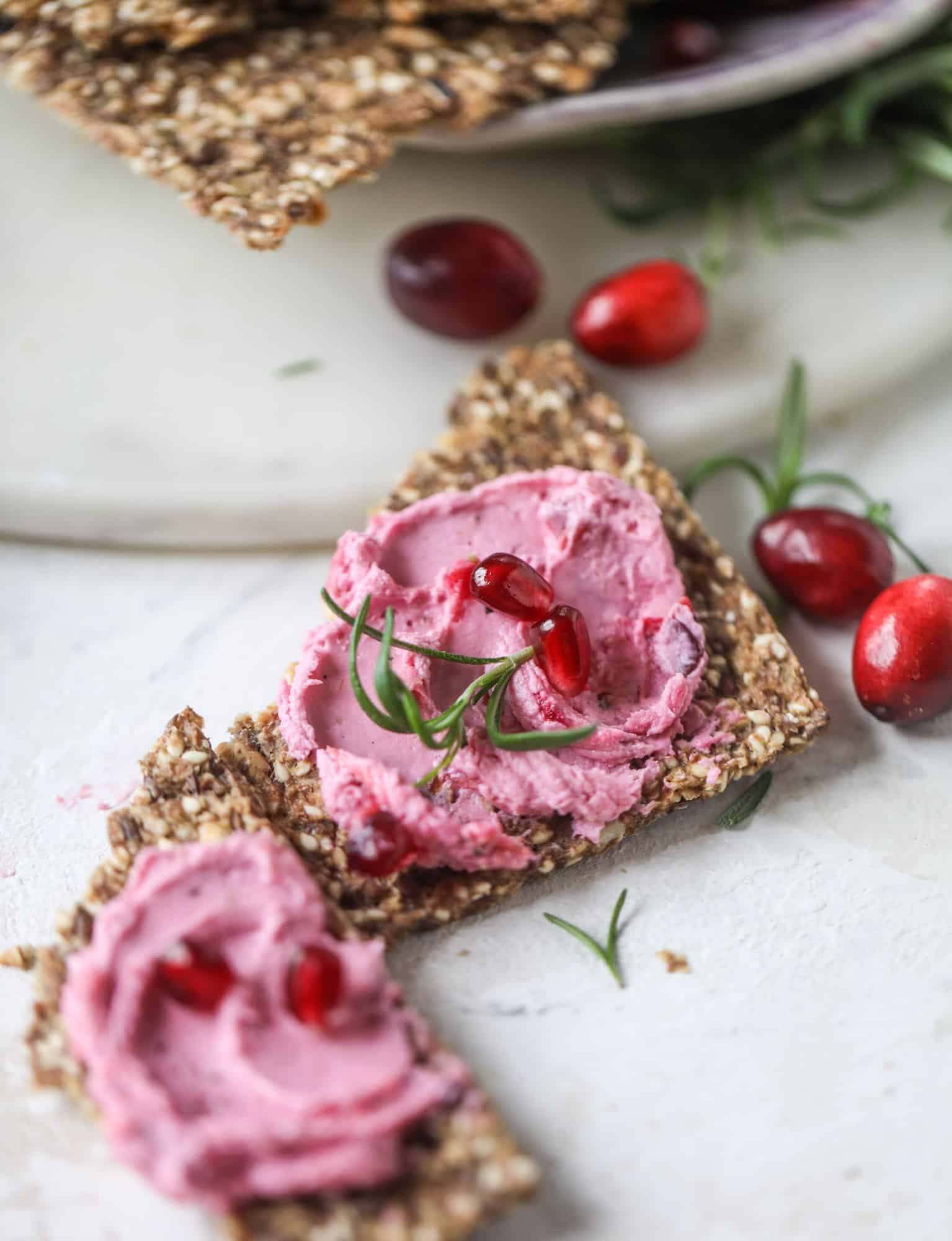 This whipped cranberry goat cheese spread is the perfect holiday appetizer! You can make it ahead of time and serve it with a cheese board or bread and crackers - before or during the meal! Plus it's super pretty too! I howsweeteats.com #cranberry #goatcheese