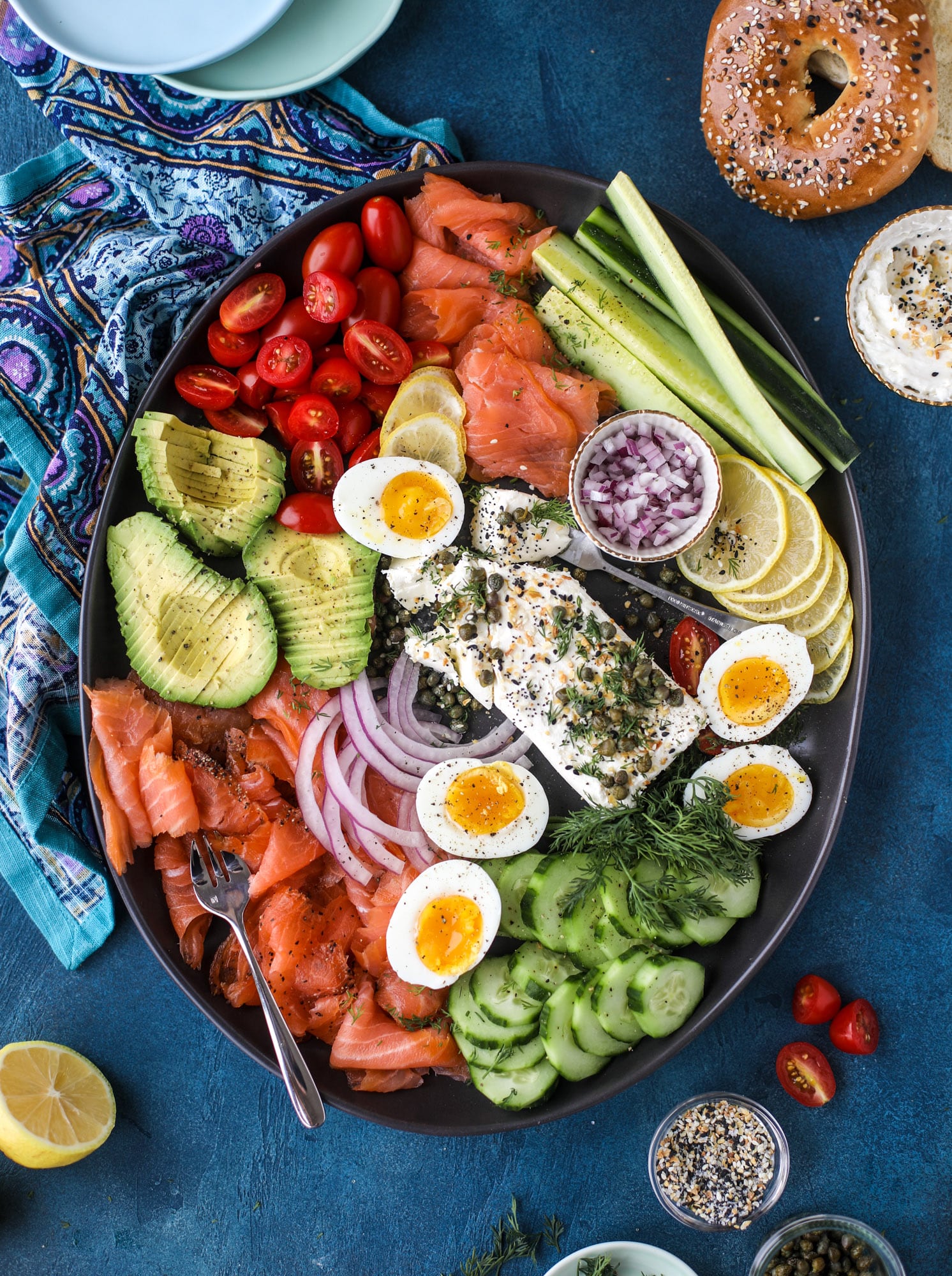 This is my favorite way to make an incredible smoked salmon platter! Fresh smoked salmon with bagels, soft boiled eggs, cream cheese and capers, everything seasoning and so much more. Perfect for holiday breakfasts and brunches! I howsweeteats.com #smokedsalmon #platter