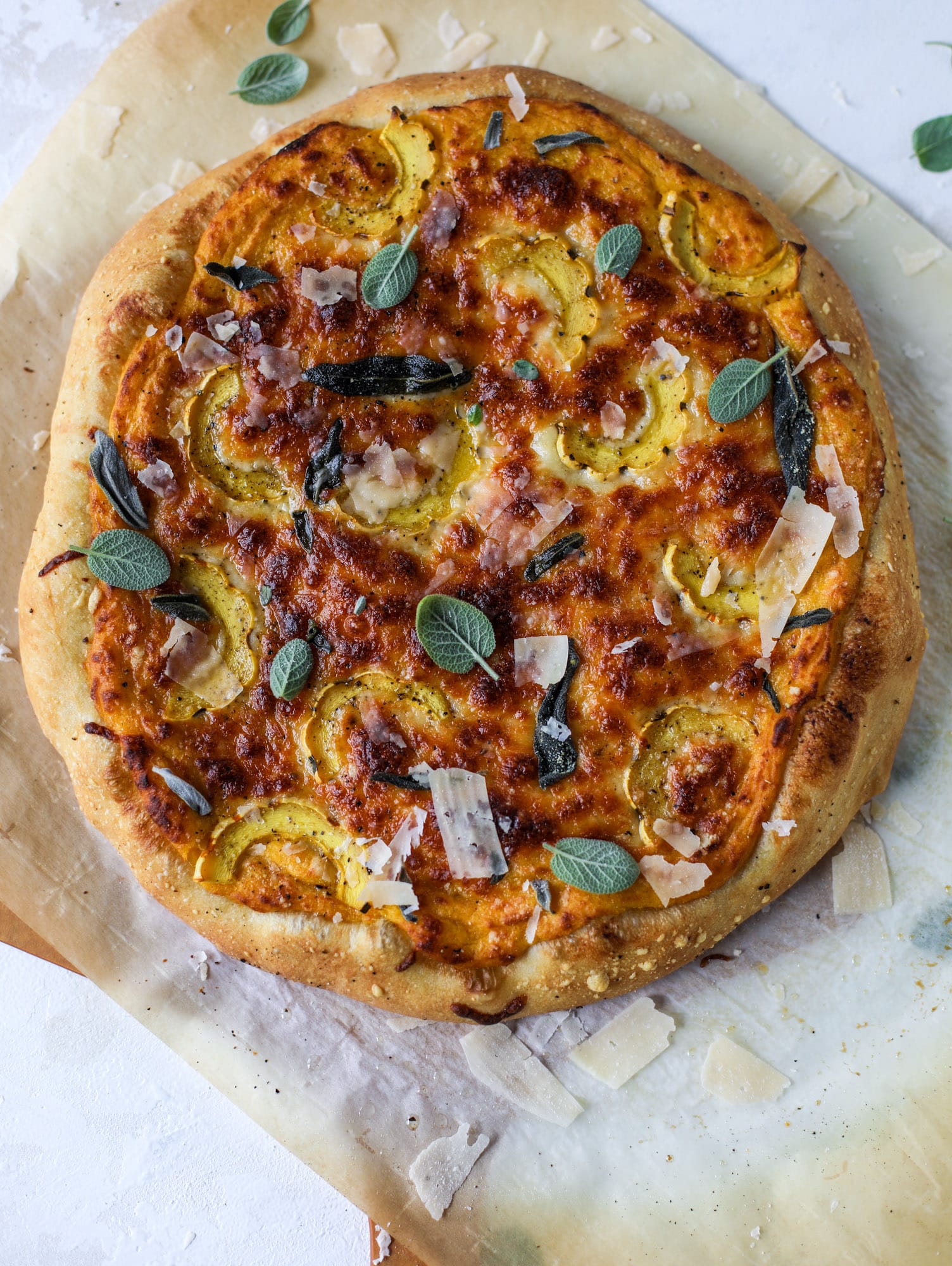 This butternut squash pizza has all the perfect tastes of fall in a pizza! Creamy butternut squash base, sharp parmesan cheese, crispy, fresh sage - it's all these and so super flavorful. It's easy too! I howsweeteats.com #butternutsquash #pizza