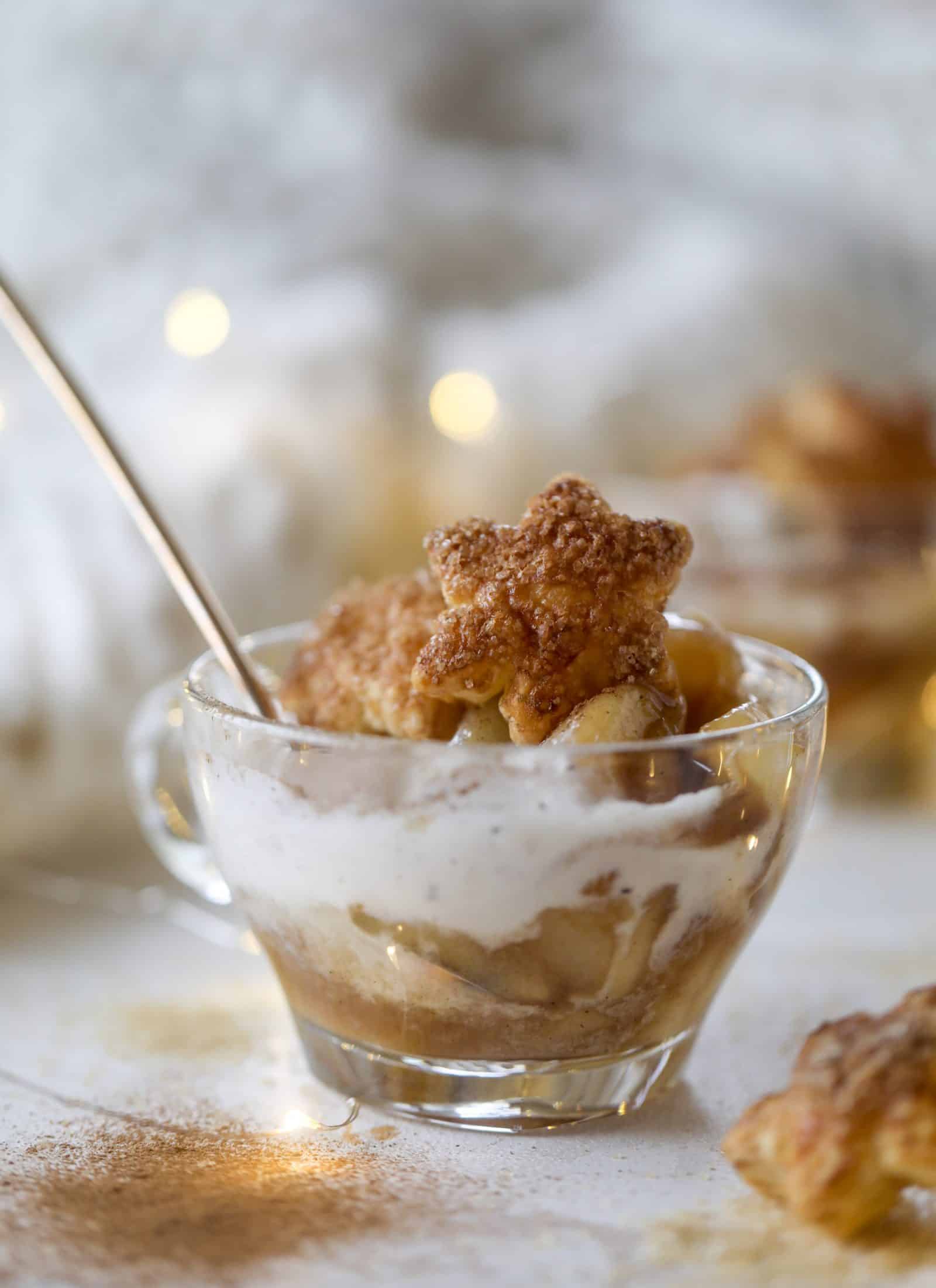 This pear mug pie is the coziest way to enjoy warm, caramelized pears. Topped with vanilla ice cream and the cutest, quick puff pastry stars, these are a great dessert for a dinner party or an easy one to make for yourself on a Saturday night! I howsweeteats.com #pear #mugpie