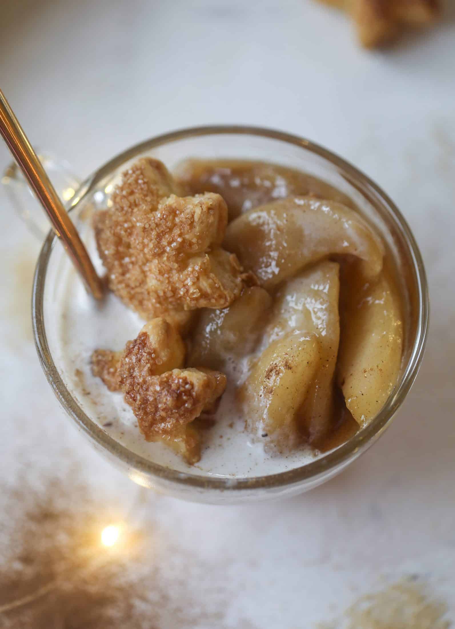 This pear mug pie is the coziest way to enjoy warm, caramelized pears. Topped with vanilla ice cream and the cutest, quick puff pastry stars, these are a great dessert for a dinner party or an easy one to make for yourself on a Saturday night! I howsweeteats.com #pear #mugpie
