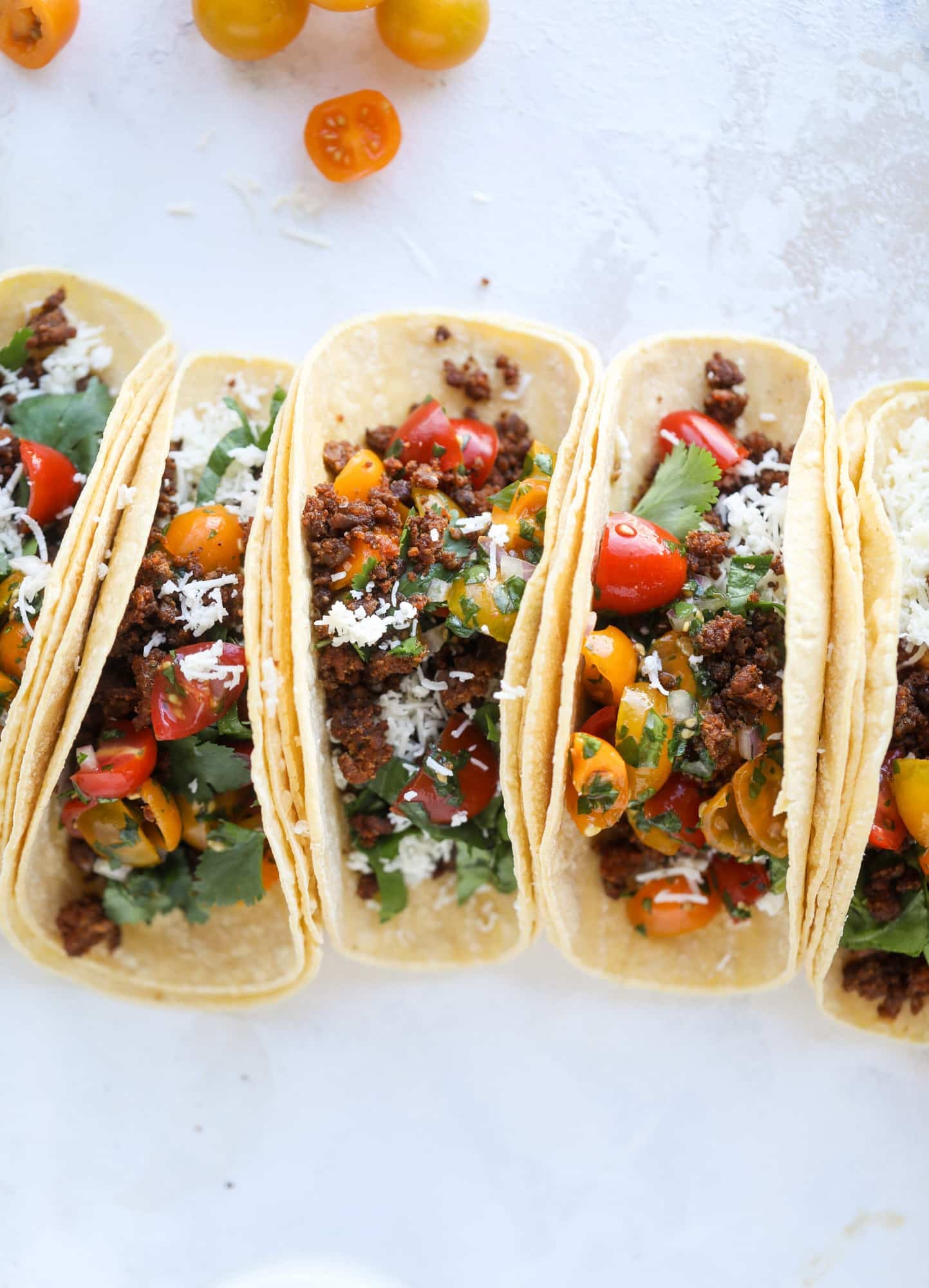 Weeknight ground beef tacos that are anything like the 90s! These are made with a homemade taco seasoning and served with the perfect toppings! I howsweeteats.com #groundbeef #tacos