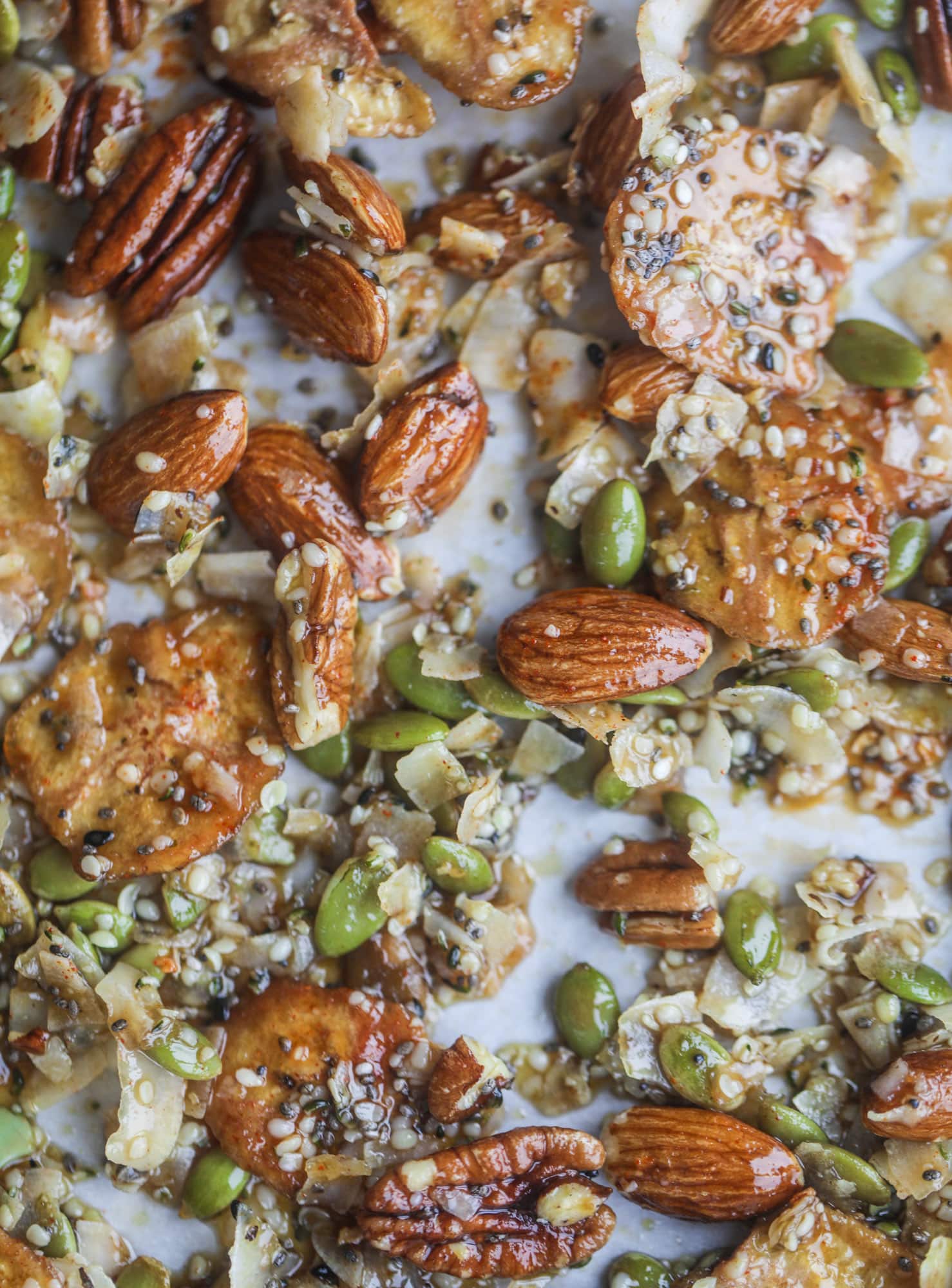 This delicious healthy snack mix is perfect to prep for snacks on the go! It's satisfying, flavorful, both sweet and savory and the best part - is super crunchy. It's full of nuts, some fruit, a bit of coconut, spices, hemp hearts and chia! I howsweeteats.com #healthy #trailmix