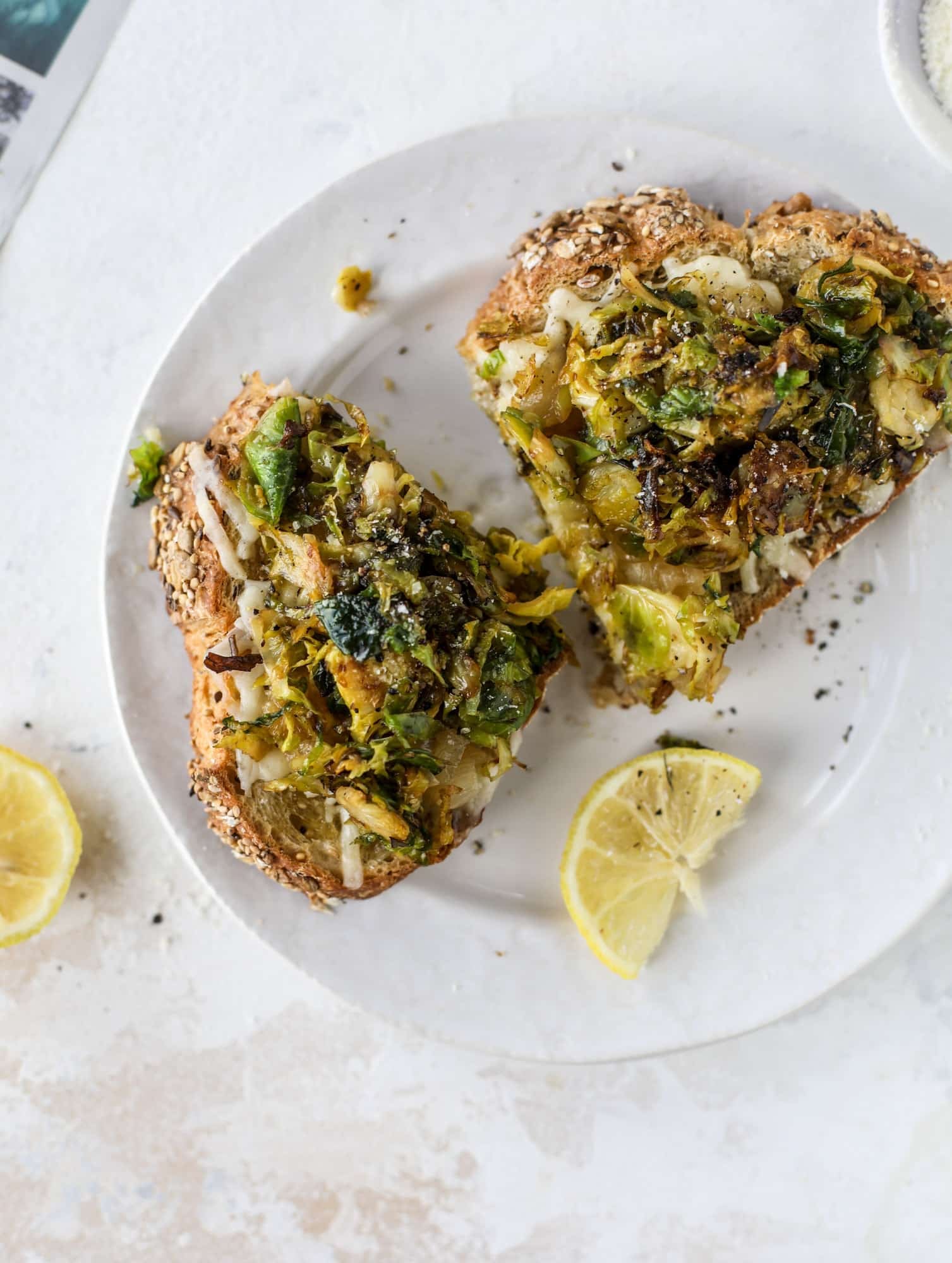 Crispy brussels sprouts toast begins with sourdough bread, melty havarti cheese and caramelized onions. It's high-maintenance toast in the best way possible. I howsweeteats.com